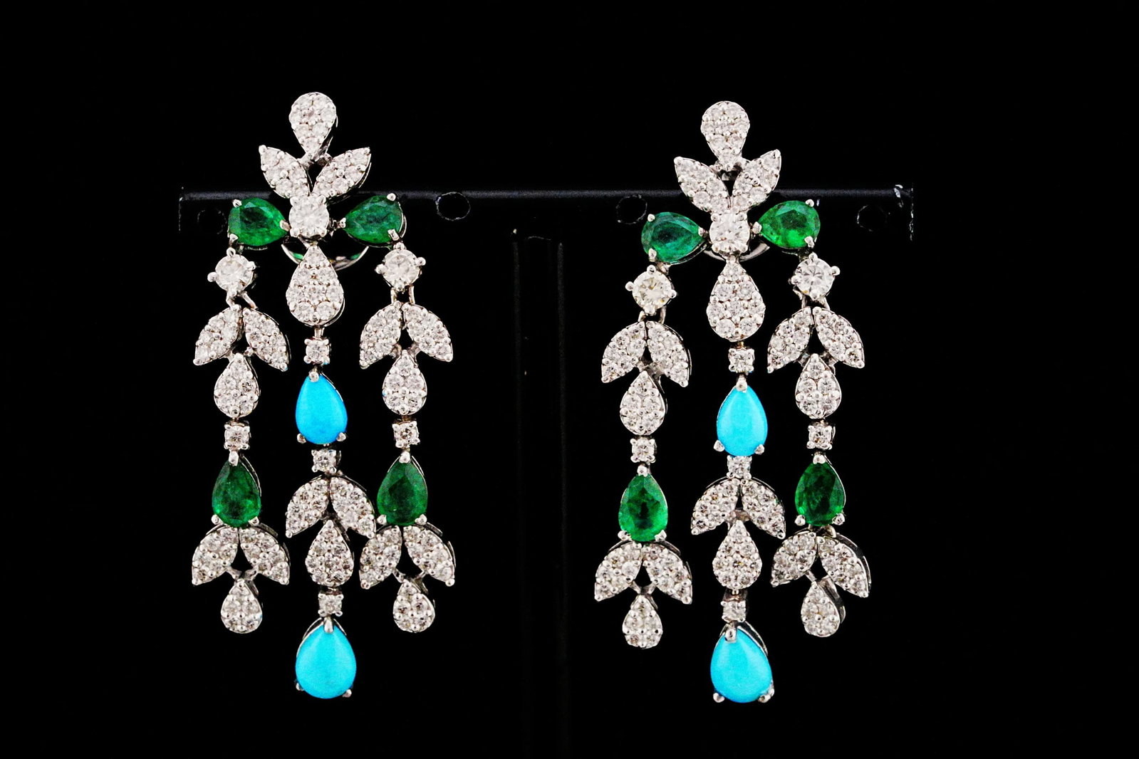 3.35ctw Diamond, 2.60ctw Emerald, Turquoise, 18K Earrings: 3.35ctw VS2-SI1/G-H Diamond, 2.60ctw Emerald, 2.00ctw Turquoise and 18K White Gold 2" Foliate Chandelier Earrings - THIS ITEM WILL COME WITH A $23,000 INSURANCE VALUATION REPORT. A vibrant and exquisi