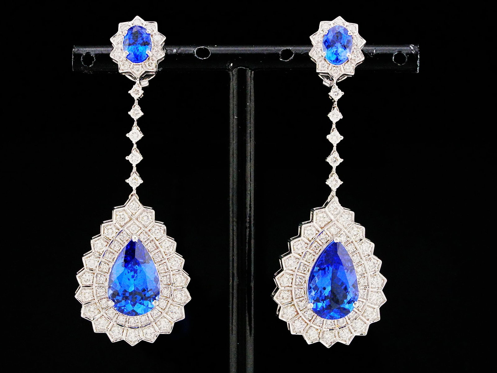 10.00ctw Tanzanite, 2.50ctw Diamond, 18K 2.25" Earrings: 10.00ctw Tanzanite, 2.50ctw VS1-VS2/G-H Diamond and 18K White Gold 2.25" Drop Earrings - THIS ITEM WILL COME WITH A $28,000 INSURANCE VALUATION REPORT. A captivating expression of elegance and vibrant
