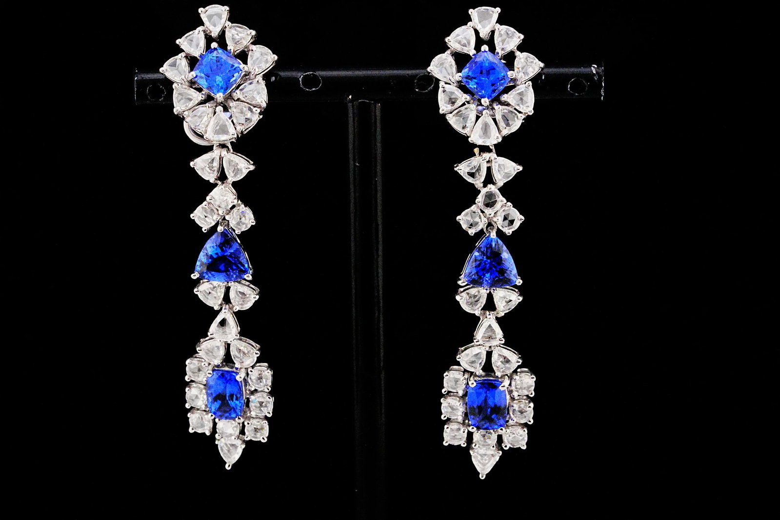 5.85ctw Tanzanite, 4.70ctw Diamond, 18K 2.5" Earrings: 5.85ctw Tanzanite, 4.70ctw Rose Cut Diamond and 18K White Gold 2.5" Drop Earrings - THIS ITEM WILL COME WITH A $22,000 INSURANCE VALUATION REPORT. A breathtaking display of artistry and color, these e
