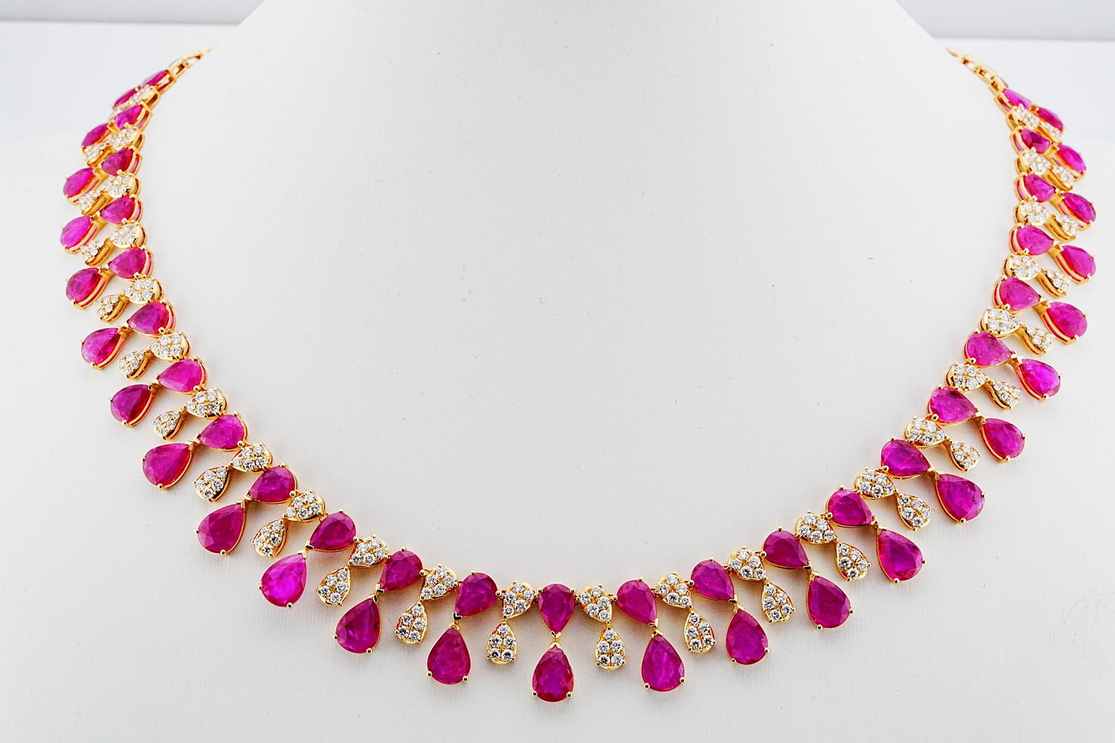 26.00ctw Ruby, 3.85ctw Diamond and 18K 16" Necklace: 26.00ctw Ruby, 3.85ctw VS1-VS2/G-H Diamond and 18K Yellow Gold 16" Graduated Fringe Necklace - THIS ITEM WILL COME WITH A $44,500 INSURANCE VALUATION REPORT. This elegant necklace showcases approximat