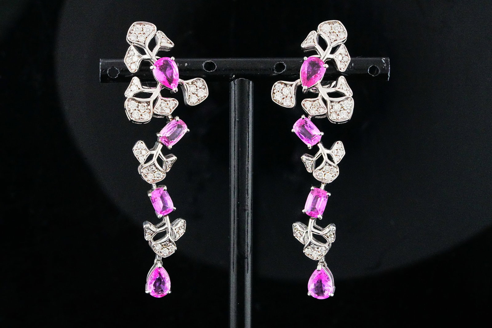5.10ctw Pink Sapphire, 1.30ctw Diamond, 18K Earrings: 5.10ctw Pink Sapphire, 1.30ctw VS1-VS2/G-H Diamond and 18K White Gold 2.25" Floral Cascade Earrings - THIS ITEM WILL COME WITH A $23,000 INSURANCE VALUATION REPORT. Elegantly designed in a graceful ca
