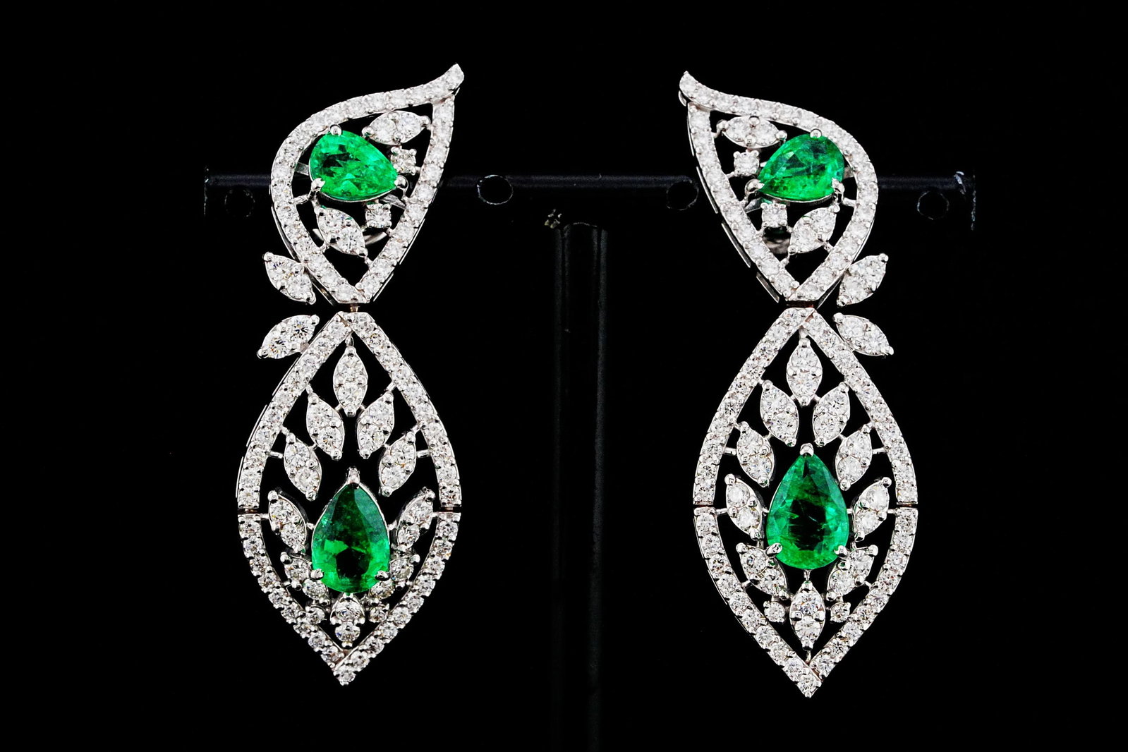 3.65ctw Emerald, 3.30ctw Diamond and 18K 2" Earrings: 3.65ctw Emerald, 3.30ctw VS2-SI1/G-H Diamond and 18K White Gold 2" Drop Earrings - THIS ITEM WILL COME WITH A $27,500 INSURANCE VALUATION REPORT. Exquisitely crafted in luxurious 18K white gold, these
