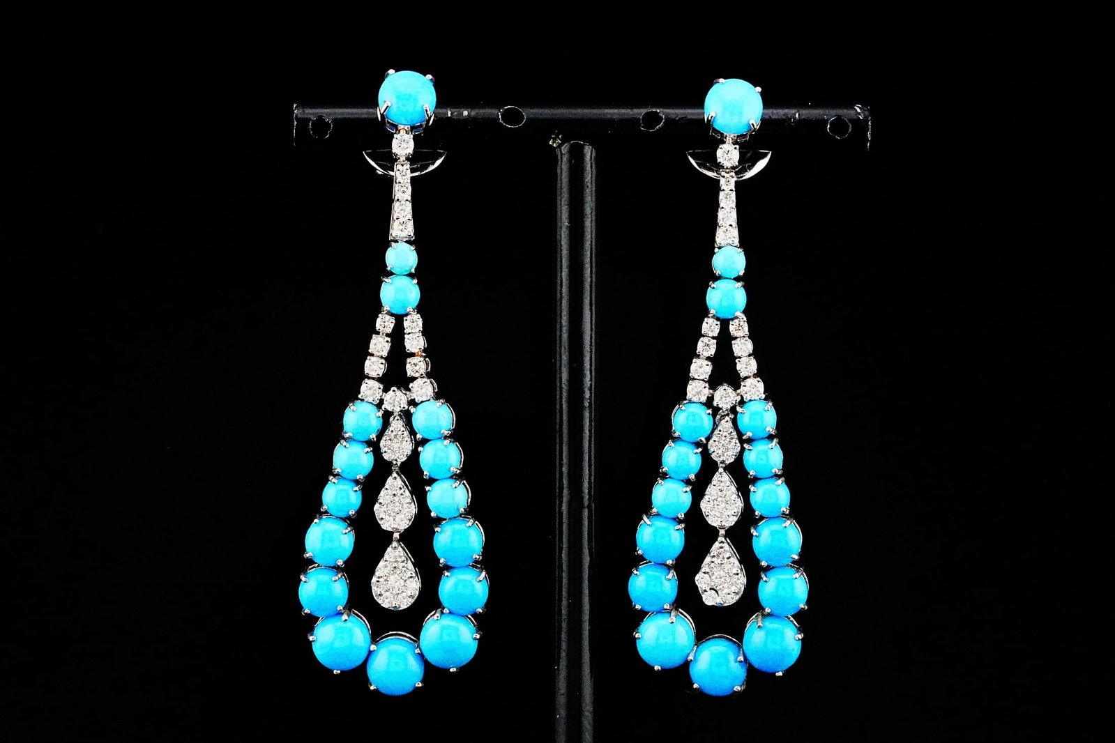 15.80ctw Turquoise, 1.40ctw Diamond and 18K Earrings: 15.80ctw Turquoise, 1.40ctw VS2-SI1/G-H Diamond and 18K White Gold 2.5" Chandelier Earrings - THIS ITEM WILL COME WITH A $22,000 INSURANCE VALUATION REPORT. Elegantly crafted in luxurious 18K white go