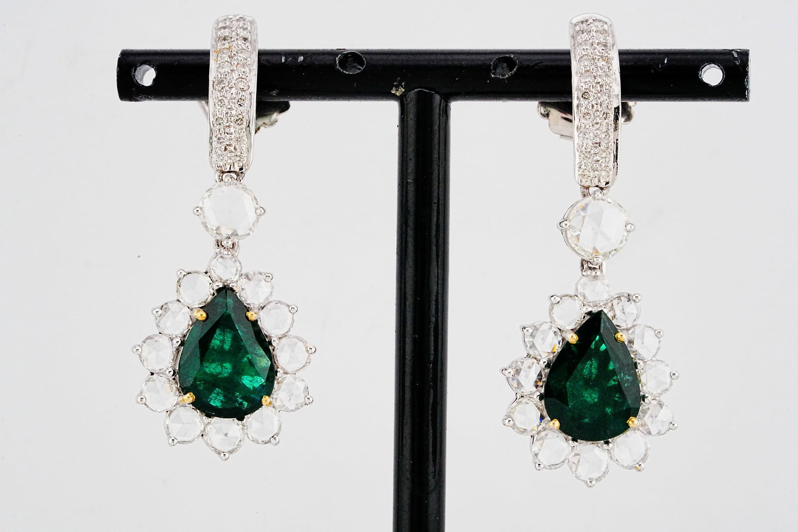 6.10ctw Emerald, 3.50ctw Diamond and 18K Earrings: 6.10ctw Emerald, 3.50ctw SI1-SI2/G-I Diamond and 18K White Gold 1.75" Drop Earrings - THIS ITEM WILL COME WITH A $22,000 INSURANCE VALUATION REPORT. Exquisitely crafted in luxurious 18K white gold, th