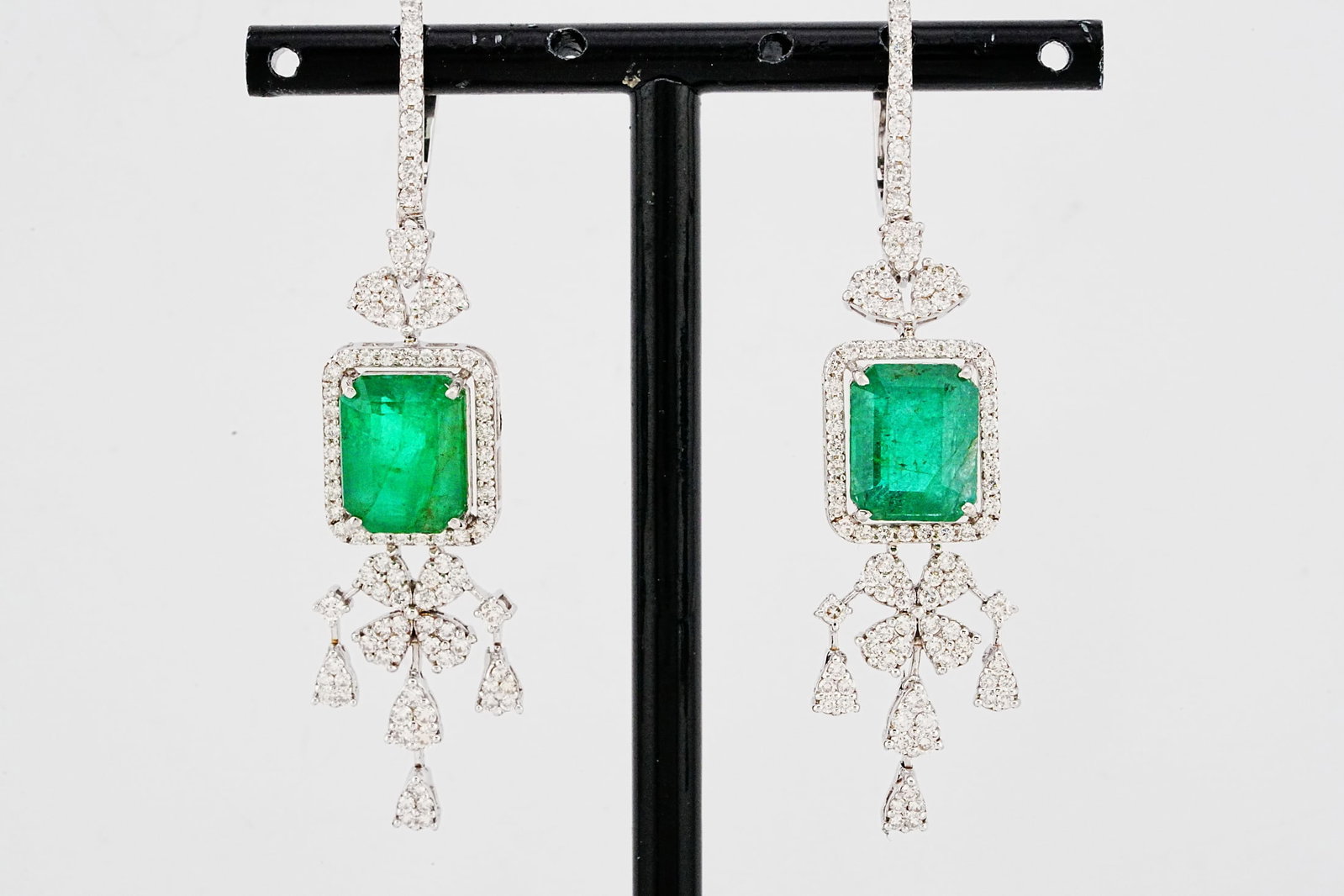 8.80ctw Emerald, 2.00ctw Diamond and 18K 2.25" Earrings: 8.80ctw Emerald, 2.00ctw VS2-SI1/G-H Diamond and 18K White Gold 2.25" Dangle Earrings - THIS ITEM WILL COME WITH A $25,500 INSURANCE VALUATION REPORT. Exquisitely crafted in luxurious 18K white gold, 