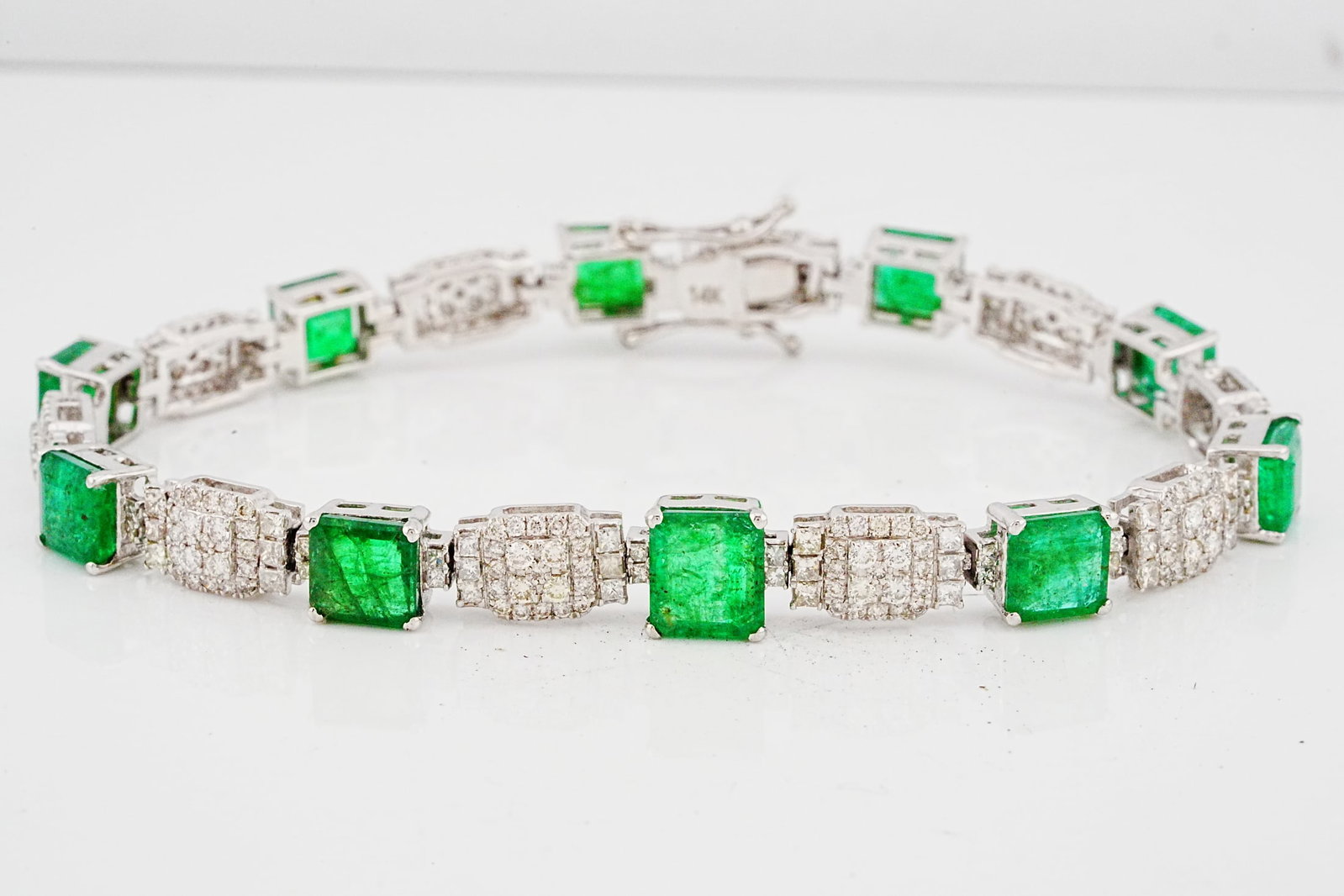 9.35ctw Emerald, 2.75ctw Diamond and 14K 7" Bracelet: 9.35ctw Emerald, 2.75ctw SI1-SI2/G-H Diamond and 14K White Gold 7" Bracelet - THIS ITEM WILL COME WITH A $14,500 INSURANCE VALUATION REPORT. Beautifully crafted in luminous 14K white gold, this elegan