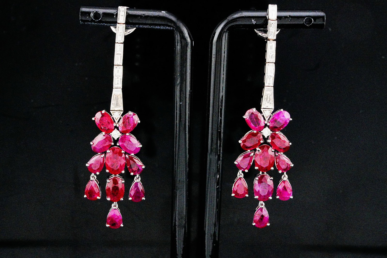 14.10ctw Ruby, 1.20ctw Diamond and 18K 2.25" Earrings: 14.10ctw Ruby, 1.20ctw VS1-VS2/G-H Diamond and 18K White Gold 2.25" Cluster Drop Earrings - THIS ITEM WILL COME WITH A $21,000 INSURANCE VALUATION REPORT. Elegant and vibrant, these striking drop earr