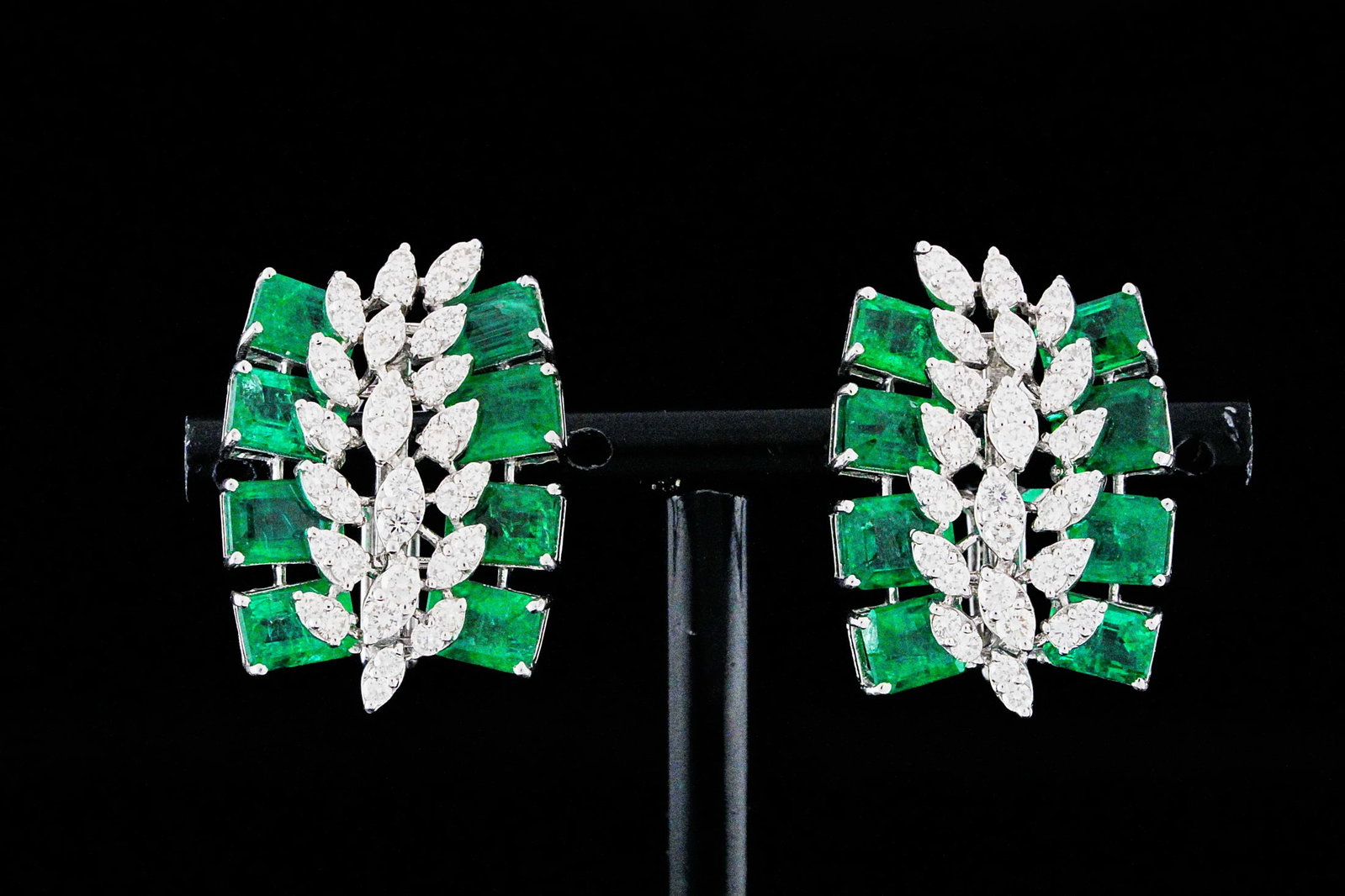 11.15ctw Emerald, 1.90ctw Diamond and 18K Earrings: 11.15ctw Emerald, 1.90ctw SI1-SI2/G-H Diamond and 18K White Gold 1.10" Spray Cluster Earrings - THIS ITEM WILL COME WITH A $25,000 INSURANCE VALUATION REPORT. These striking vintage-inspired spray clu