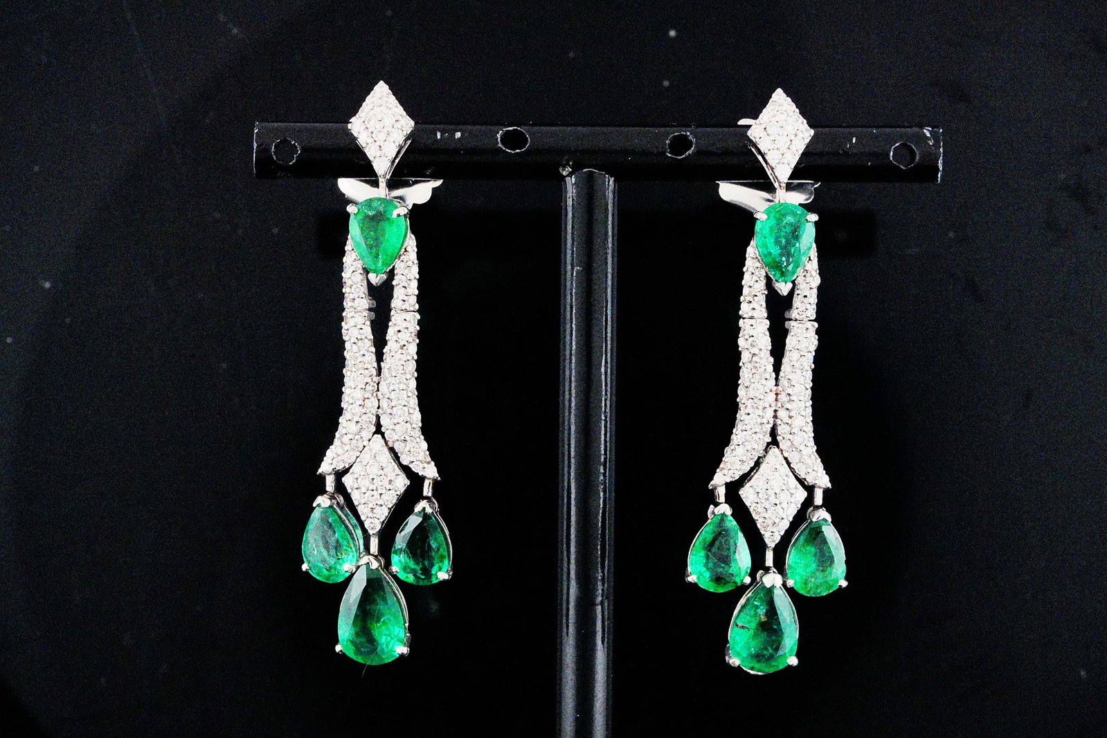 5.30ctw Emerald, 1.60ctw Diamond and 18K 2" Earrings: 5.30ctw Emerald, 1.60ctw SI1-SI2/G-H Diamond and 18K White Gold 2" Dangle Earrings - THIS ITEM WILL COME WITH A $20,000 INSURANCE VALUATION REPORT. A striking display of elegance and movement, these e