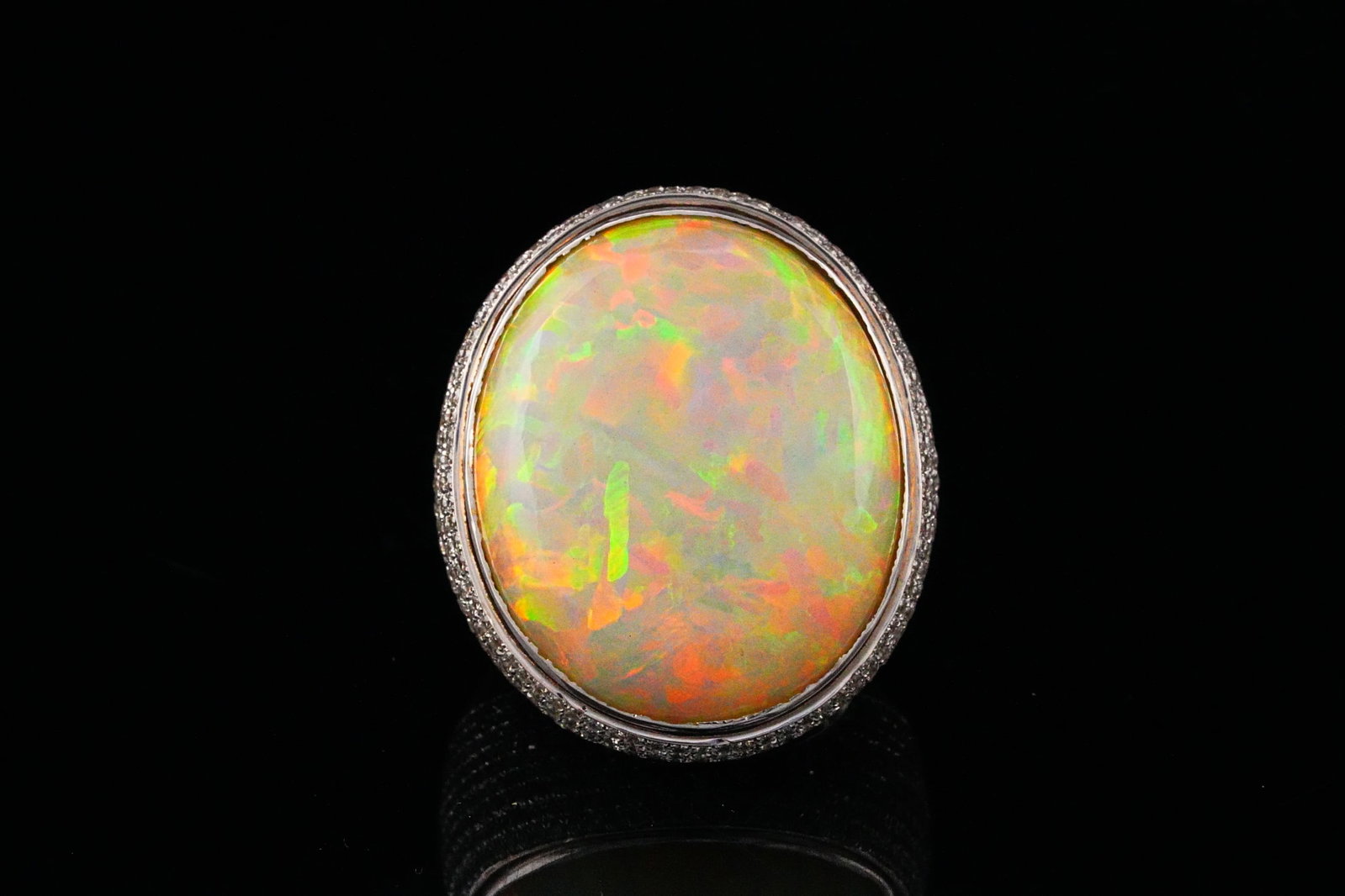 30.90ct Opal, 2.80ctw Diamond and 18K Statement Ring: 30.90ct Opal, 2.80ctw SI1-SI2/G-H Diamond and 18K White Gold Statement Ring - THIS ITEM WILL COME WITH A $20,000 INSURANCE VALUATION REPORT. A truly extraordinary and commanding piece, this spectacula