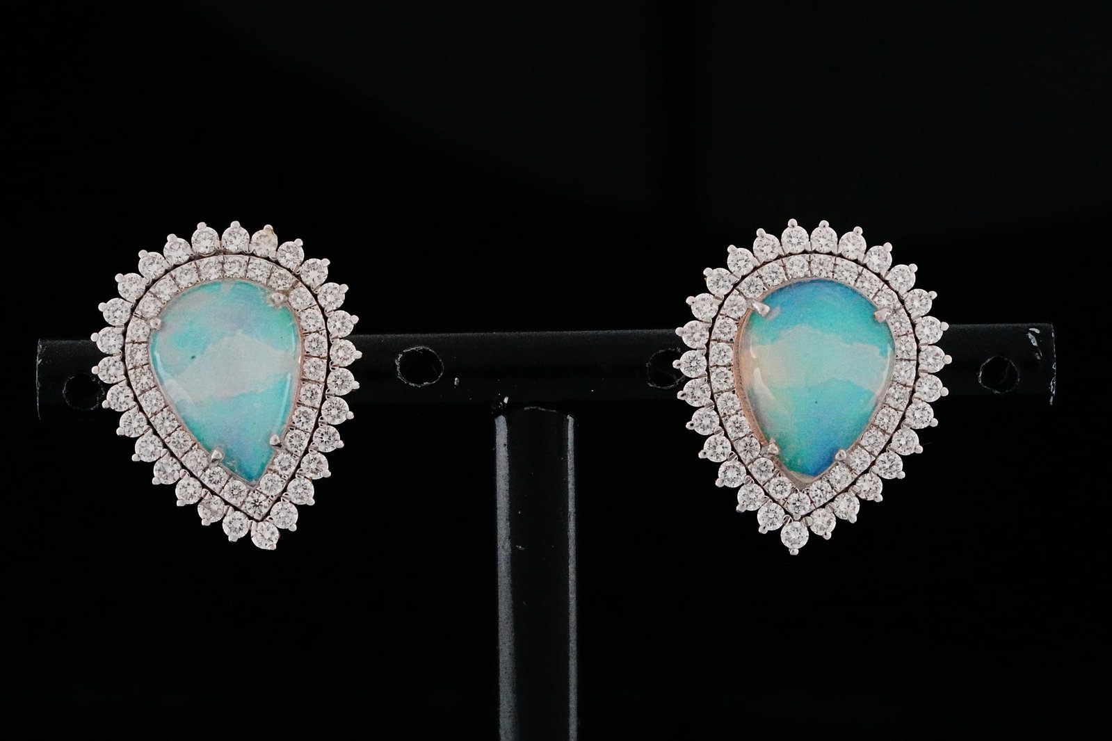 5.60ctw Opal, 0.80ctw Diamond and 18K Earrings: 5.60ctw Opal, 0.80ctw VS1-SI1/G-H Diamond and 18K White Gold 0.75" Teardrop Earrings - THIS ITEM WILL COME WITH A $7,500 INSURANCE VALUATION REPORT. A captivating blend of ethereal beauty and refined 