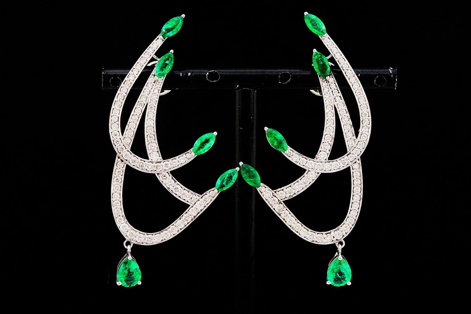 3.00ctw Emerald, 2.00ctw Diamond and 18K 2.25" Earrings: 3.00ctw Emerald, 2.00ctw VS2-SI1/G-H Diamond and 18K White Gold 2.25" Scroll Drop Earrings - THIS ITEM WILL COME WITH A $15,000 INSURANCE VALUATION REPORT. A graceful expression of nature-inspired ele