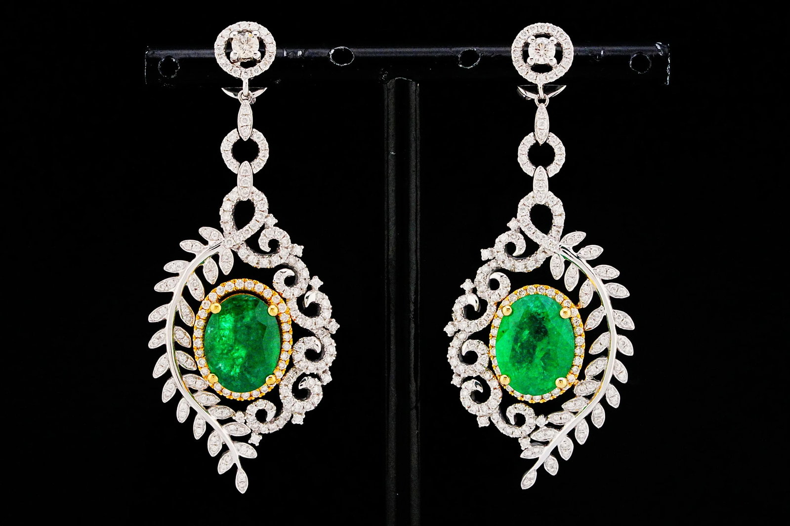 6.75ctw Emerald, 2.00ctw Diamond and 18K 2.10" Earrings: 6.75ctw Emerald, 2.00ctw SI1-SI2/G-H Diamond and 18K White/Yellow Gold 2.10" Vine Drop Earrings - THIS ITEM WILL COME WITH A $16,000 INSURANCE VALUATION REPORT. A romantic expression of nature-inspire
