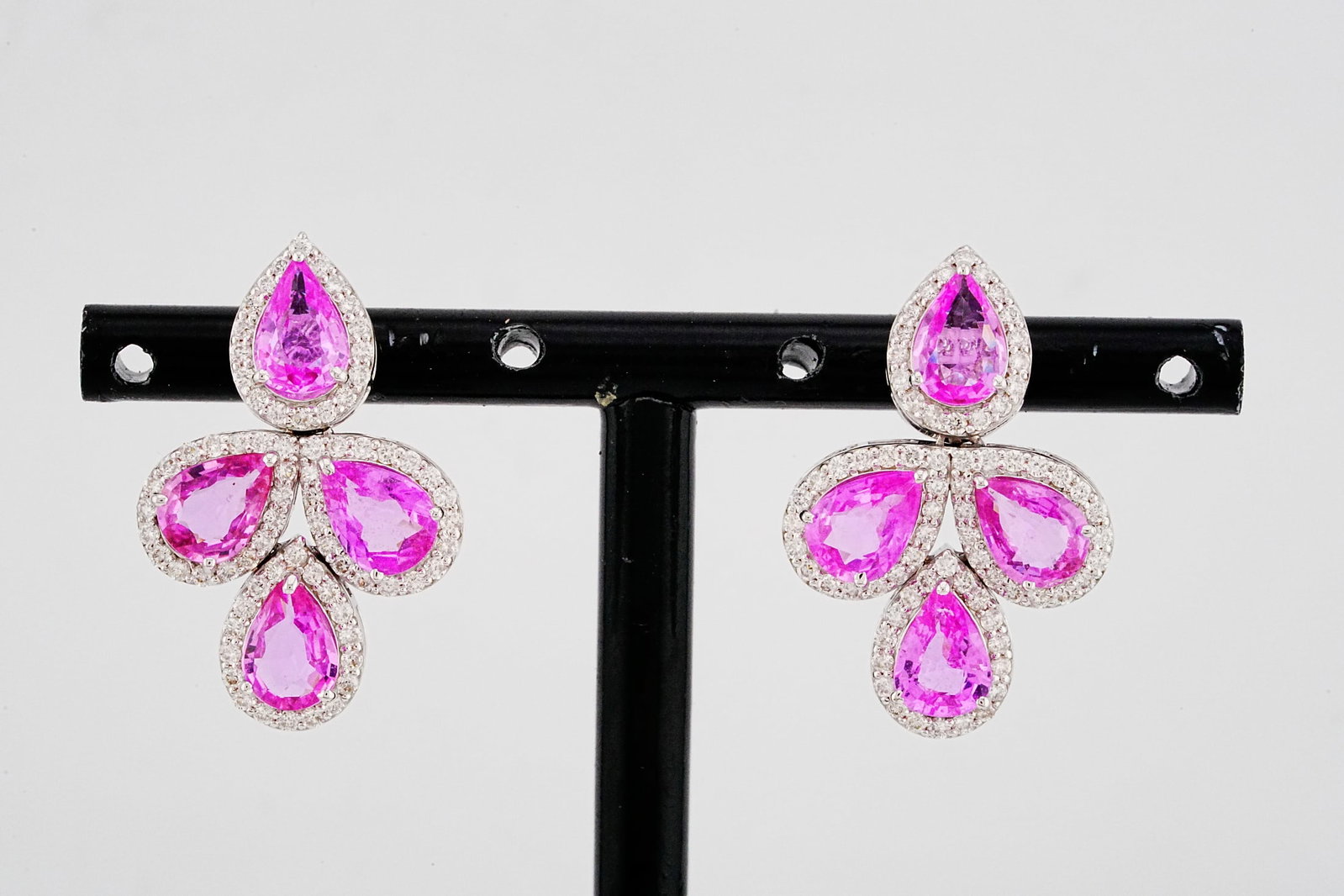 5.40ctw Pink Sapphire, 1.00ctw Diamond and 18K Earrings: 5.40ctw Pink Sapphire, 1.00ctw SI1-SI2/G-H Diamond and 18K White Gold 1" Earrings - THIS ITEM WILL COME WITH A $14,000 INSURANCE VALUATION REPORT. Beautifully crafted in polished 18K white gold, these