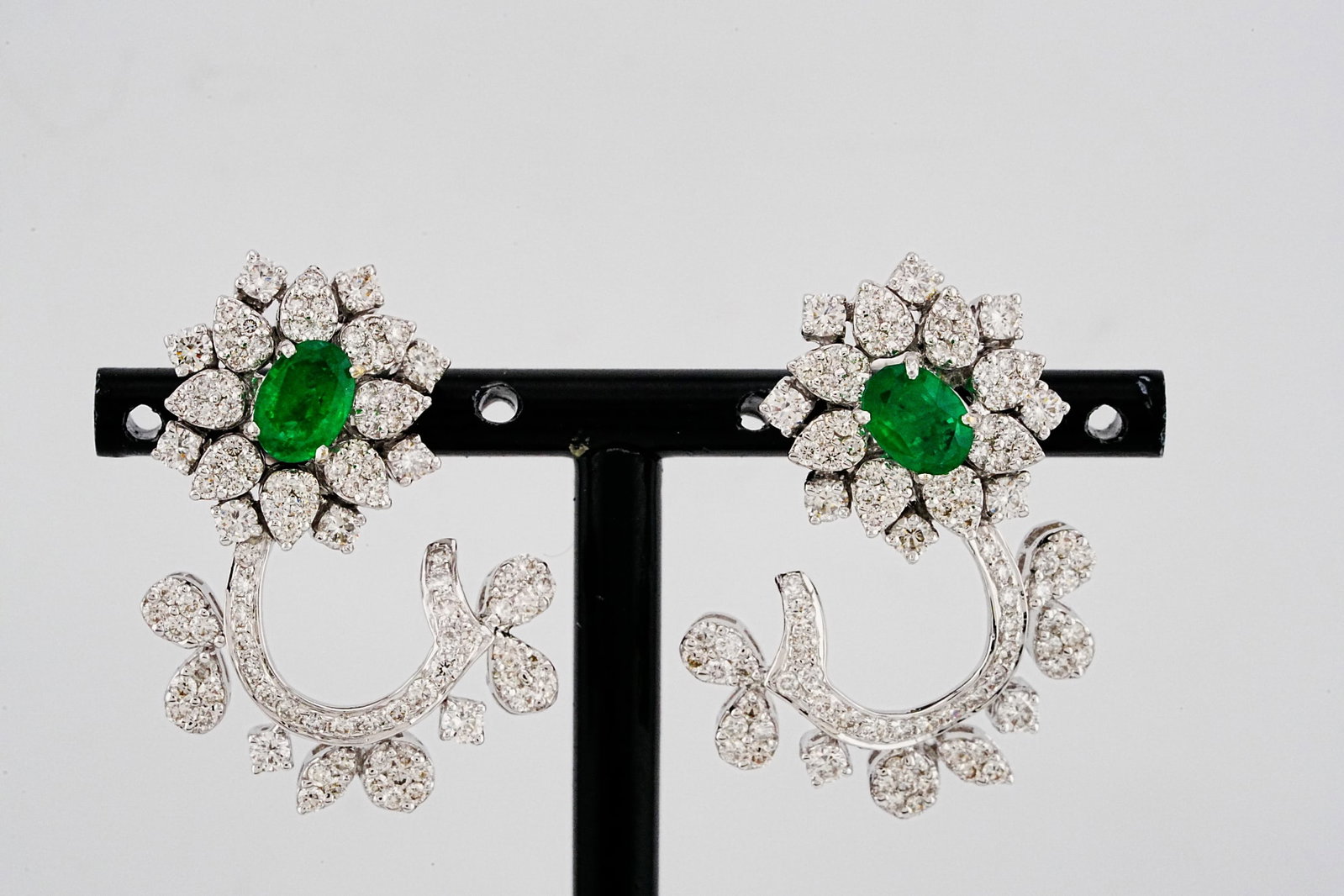 3.20ctw Diamond, 1.40ctw Emerald and 18K Earrings: 3.20ctw VS1-SI1/G-H Diamond, 1.40ctw Emerald and 18K White Gold 1.25" Earrings - THIS ITEM WILL COME WITH A $14,500 INSURANCE VALUATION REPORT. Exquisitely crafted in luminous 18K white gold, these el