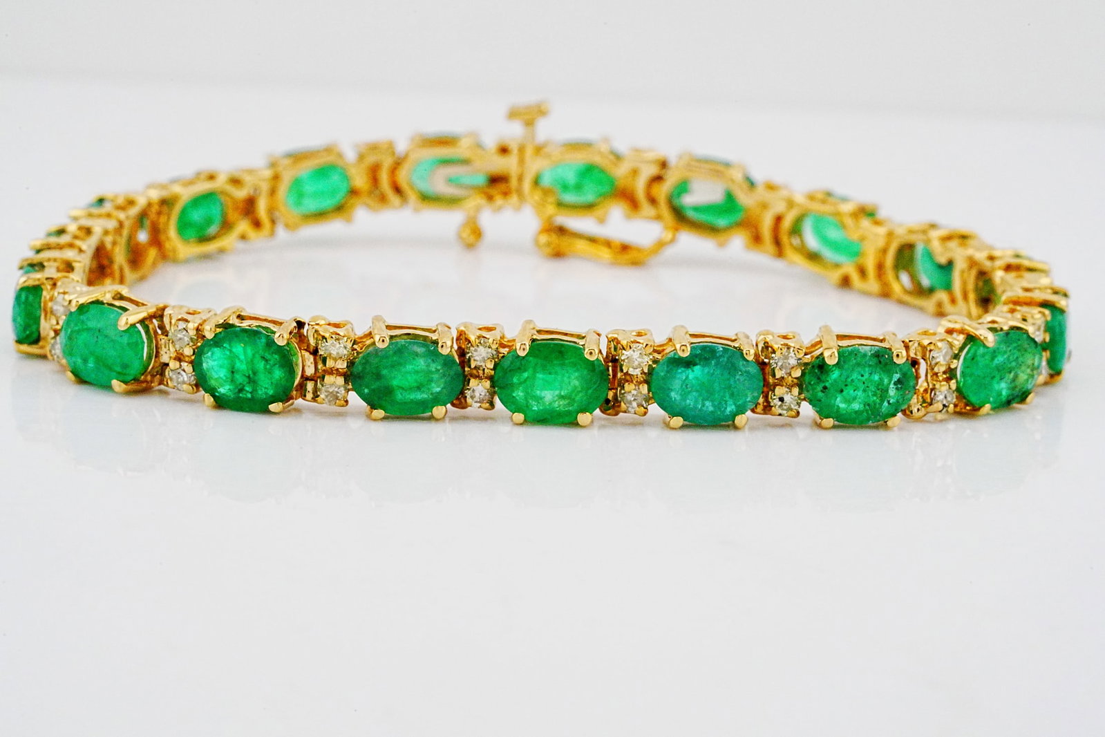 15.00ctw Emerald, 1.00ctw Diamond and 14K 7" Bracelet: 15.00ctw Emerald, 1.00ctw SI1-SI2/G-H Diamond and 14K Yellow Gold 7" Bracelet - THIS ITEM WILL COME WITH A $13,000 INSURANCE VALUATION REPORT. Luxurious 14K yellow gold bracelet featuring a vibrant ar