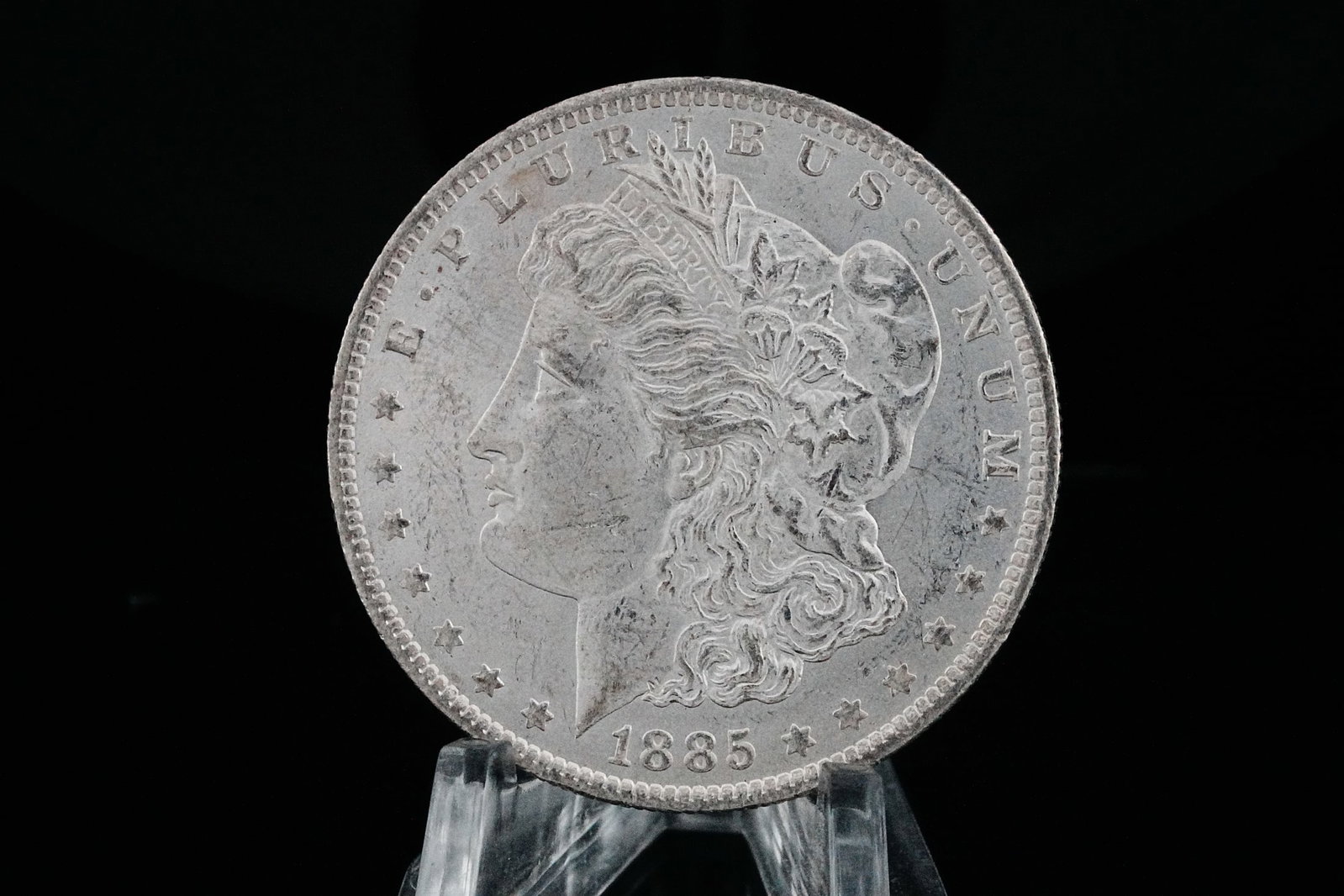 1885-O Morgan Silver Dollar W/Toned Rim MS65+: 1885-O Morgan Silver Dollar W/Toned Rim MS65+ (90% Silver) - Truly a magnificent example, this exceptional 1885-O Morgan Silver Dollar presents with outstanding preservation and breathtaking eye appea