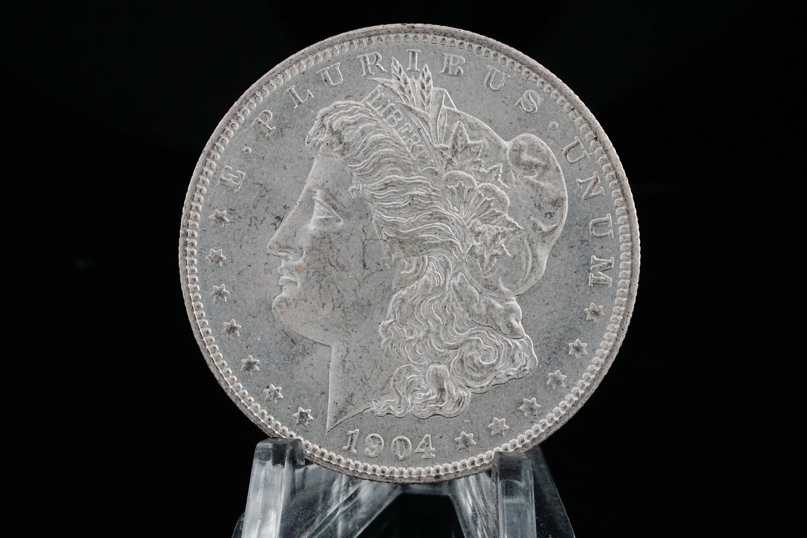 1904-O Morgan Silver Dollar MS65+ (90% Silver): 1904-O Morgan Silver Dollar MS65+ (90% Silver) - A truly stunning gem-quality example, this 1904-O Morgan Silver Dollar boasts exceptional preservation with blazing original mint luster shimmering acr