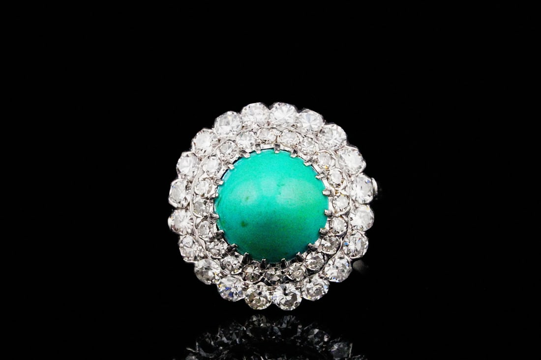 2.00ctw Diamond, 10.5mm Turquoise and Platinum Ring: 2.00ctw VS2-SI1/G-H Diamond, 10.5mm Turquoise and Platinum Ring - This striking ring showcases a vibrant 10.5mm turquoise cabochon at its center, prized for its rich, saturated color and smooth, polis