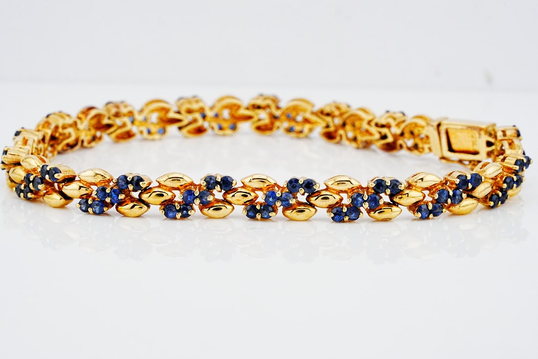 1.90ctw Blue Sapphire and 14K Yellow Gold 7" Bracelet: 1.90ctw Blue Sapphire and 14K Yellow Gold 7" Bracelet - This elegant bracelet showcases a refined arrangement of vivid blue sapphires totaling approximately 1.90 carats, each selected for its rich sat