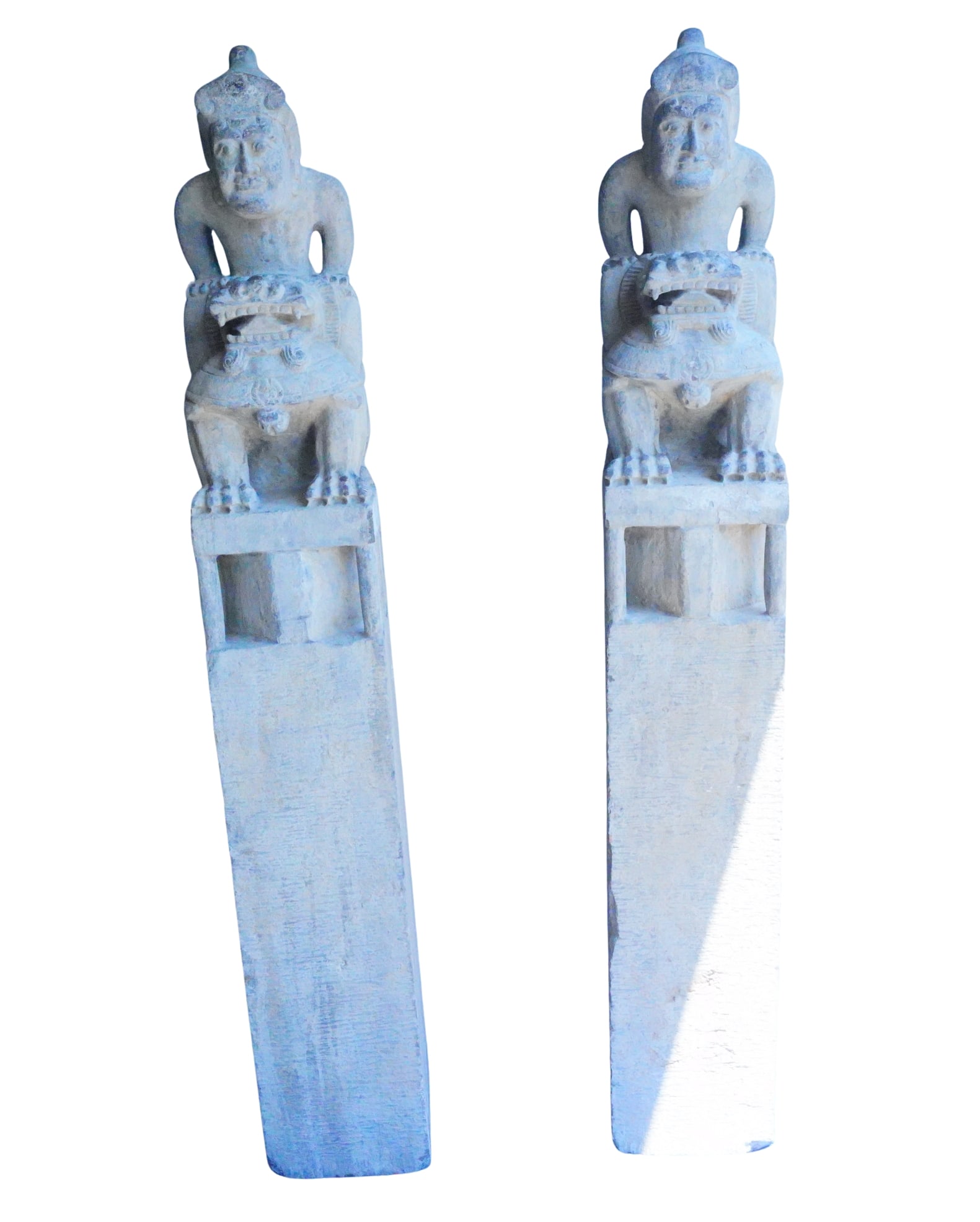 Pair of Monumental Carved Stone Guardian Figures: Pair of Monumental Carved Stone Guardian Figures on Plinths - An impressive pair of monumental carved stone guardian figures, each raised on a tall rectangular plinth. The sculptural design features a