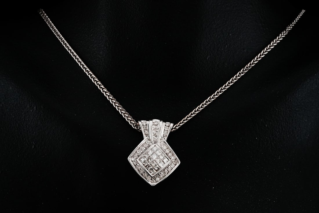 14K White Gold and 0.65ctw Diamond 16" Necklace: 14K White Gold and 0.65ctw Diamond 16" Necklace - This necklace is crafted in 14k white gold and has a pendant embellished with approximately 0.65ctw round and princess-cut diamonds. Measurements: Cha