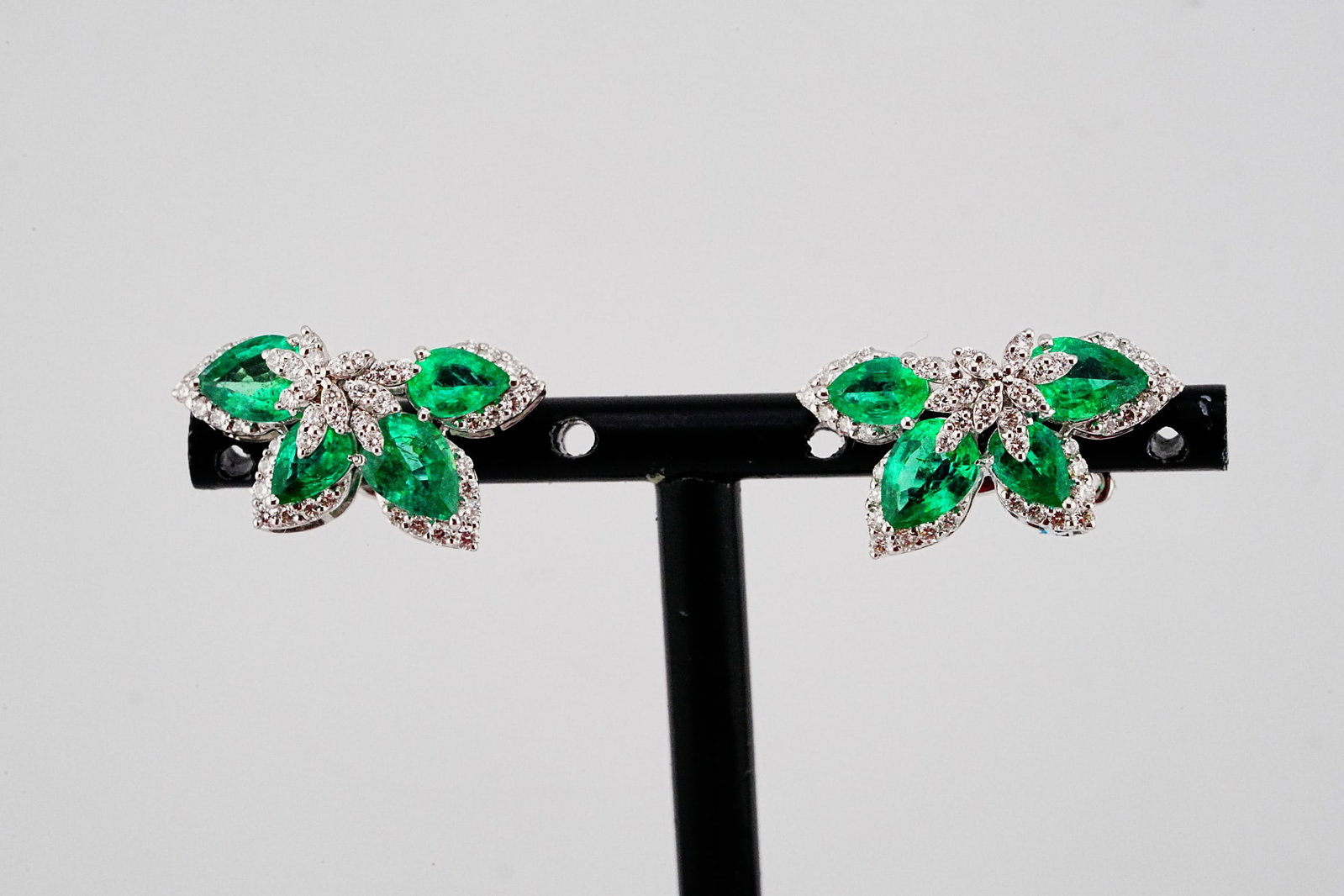 4.00ctw Emerald, 0.80ctw Diamond and 18K Earrings: 4.00ctw Emerald, 0.80ctw Diamond and 18K White Gold 0.85" Stud Earrings - THIS ITEM WILL COME WITH A $13,500 INSURANCE VALUATION REPORT. Uniquely elegant and beautifully crafted, these striking stud e