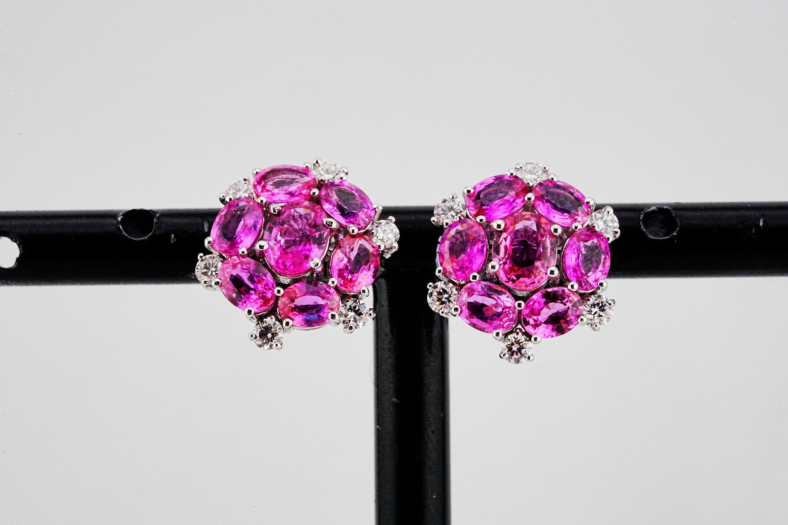 3.60ctw Pink Sapphire, 0.40ctw Diamond and 18K Earrings: 3.60ctw Pink Sapphire, 0.40ctw Diamond and 18K White Gold 0.50" Stud Earrings - THIS ITEM WILL COME WITH AN $8,500 INSURANCE VALUATION REPORT. These graceful stud earrings are crafted in gleaming 18k 