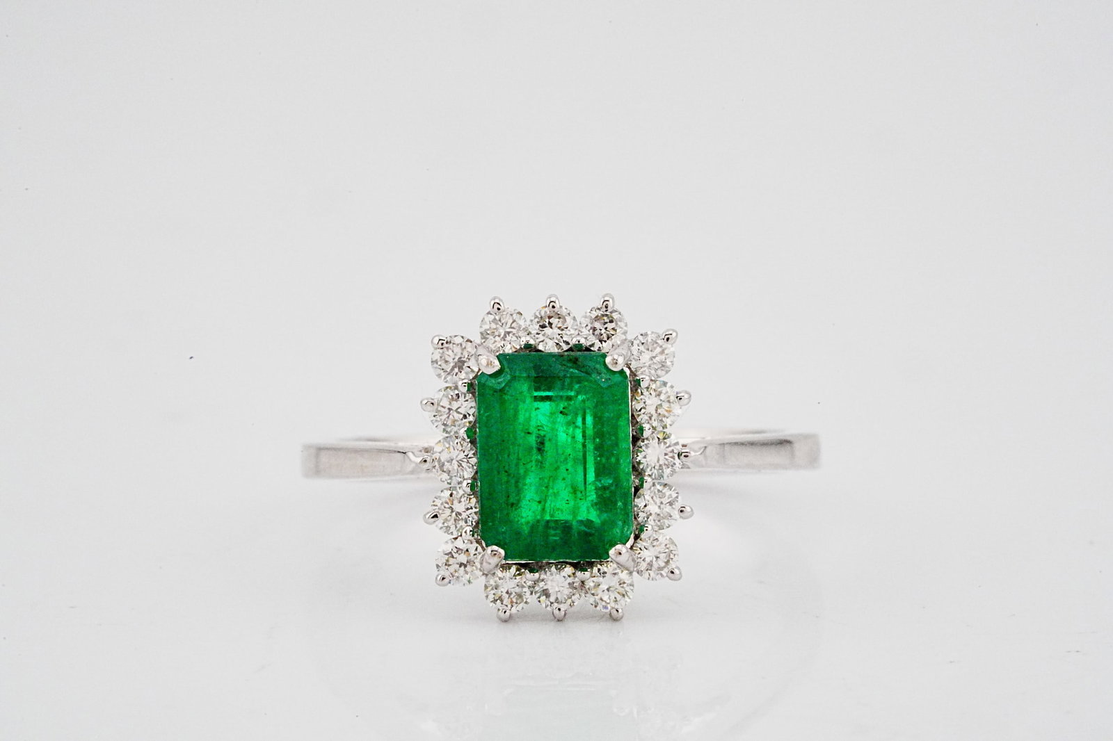 1.45ct Emerald, 0.40ctw Diamond and 18K White Gold Ring: 1.45ct Emerald, 0.40ctw Diamond and 18K White Gold Ring - THIS ITEM WILL COME WITH A $6,500 INSURANCE VALUATION REPORT. This lovely ring is crafted in 18k white gold and showcases an approximately 1.4