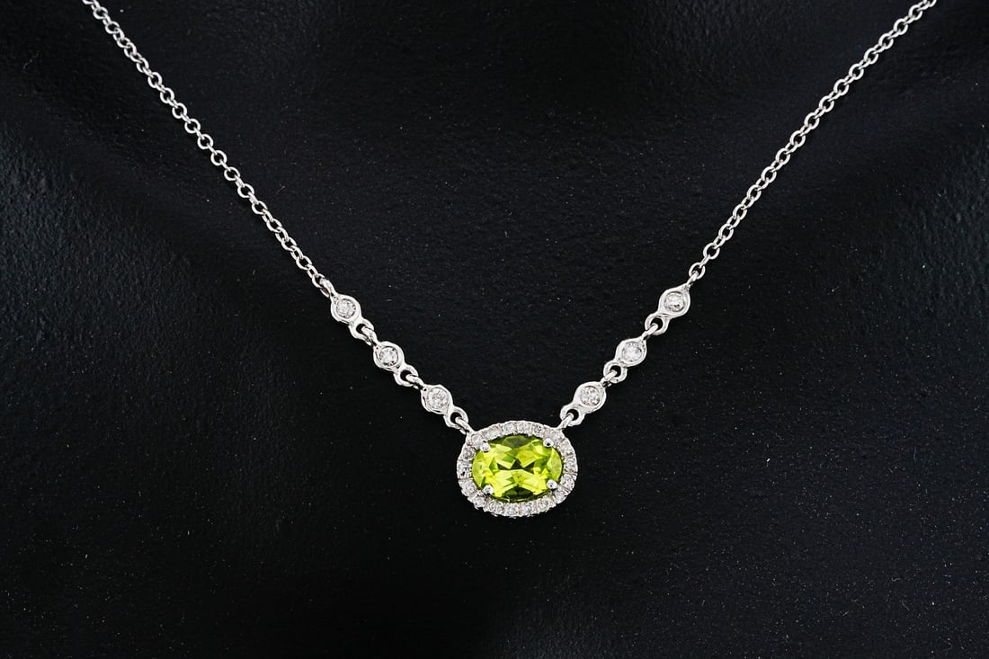 14K White Gold, 0.75ct Peridot and Diamond Necklace: 14K White Gold, 0.75ct Peridot and 0.15ctw Diamond 16" Necklace - This necklace is crafted in 14K white gold and features a peridot weighing approximately 0.75 carats, displaying a bright green