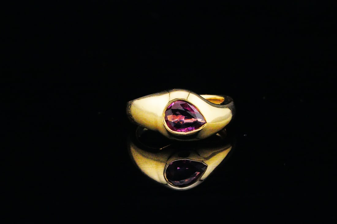 18K Yellow Gold and 0.50ct Pink Sapphire Pinky/Midi Ring: Fortuna 18K Yellow Gold and 0.50ct Pink Sapphire Pinky/Midi Ring - This ring is crafted in 18K yellow gold and features a bezel-set pear cut pink sapphire weighing approximately 0.50 carats. The