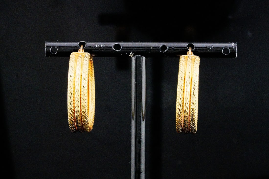 14K Yellow Gold 1" Hoop Earrings: 14K Yellow Gold 1" Hoop Earrings - These earrings are crafted in 14k yellow gold and have a richly textured three-row design. Measurements: 1" length. Weight: 4.5 grams. AUCTION NOTE: This item comes