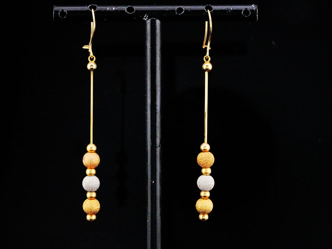 18K Tri-Color Gold 2.5" Dangle Earrings: 18K Tri-Color Gold 2.5" Dangle Earrings - These earrings have an 18k tri-color gold design with a yellow gold construction and textured yellow, white and rose gold beads. Measurements: 2.5" length.