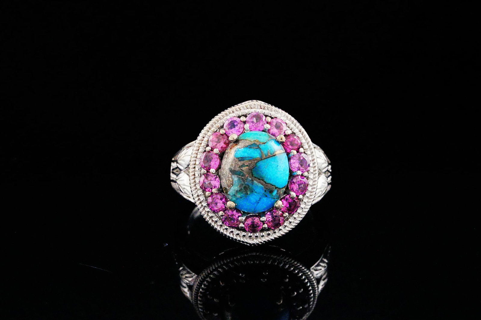 12mm Turquoise, Pink Tourmaline and Sterling Silver Ring: 12mm Turquoise, 1.40ctw Pink Tourmaline and Sterling Silver Ring - This ring is crafted in sterling silver and showcases a beautiful 12mm turquoise with a vivid blue color and deep brown matrix. The t