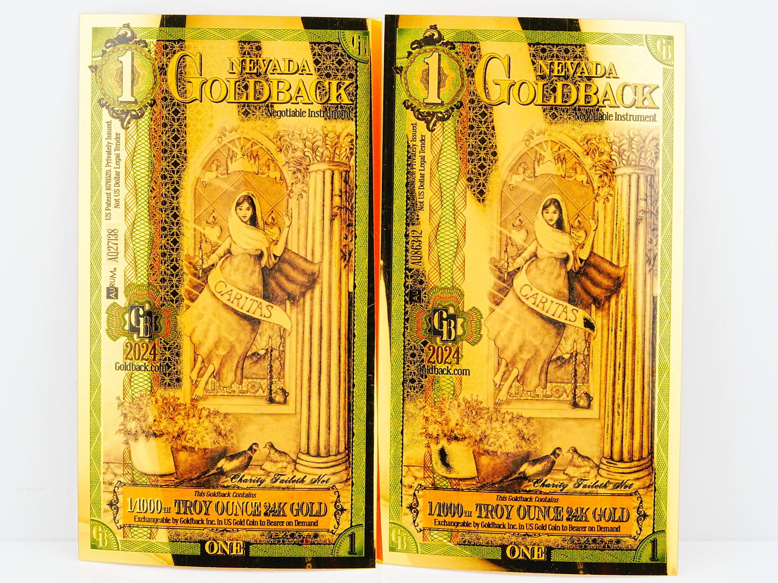 Lot of (2) 1 Nevada Goldbacks 1/1000th Ounce 24K Gold: Lot of (2) 1 Nevada Goldbacks 1/1000th Troy Ounce 24K Gold - A collectible lot of two Nevada Goldbacks, each containing 1/1000th troy ounce of 24K gold embedded within a beautifully detailed spendable