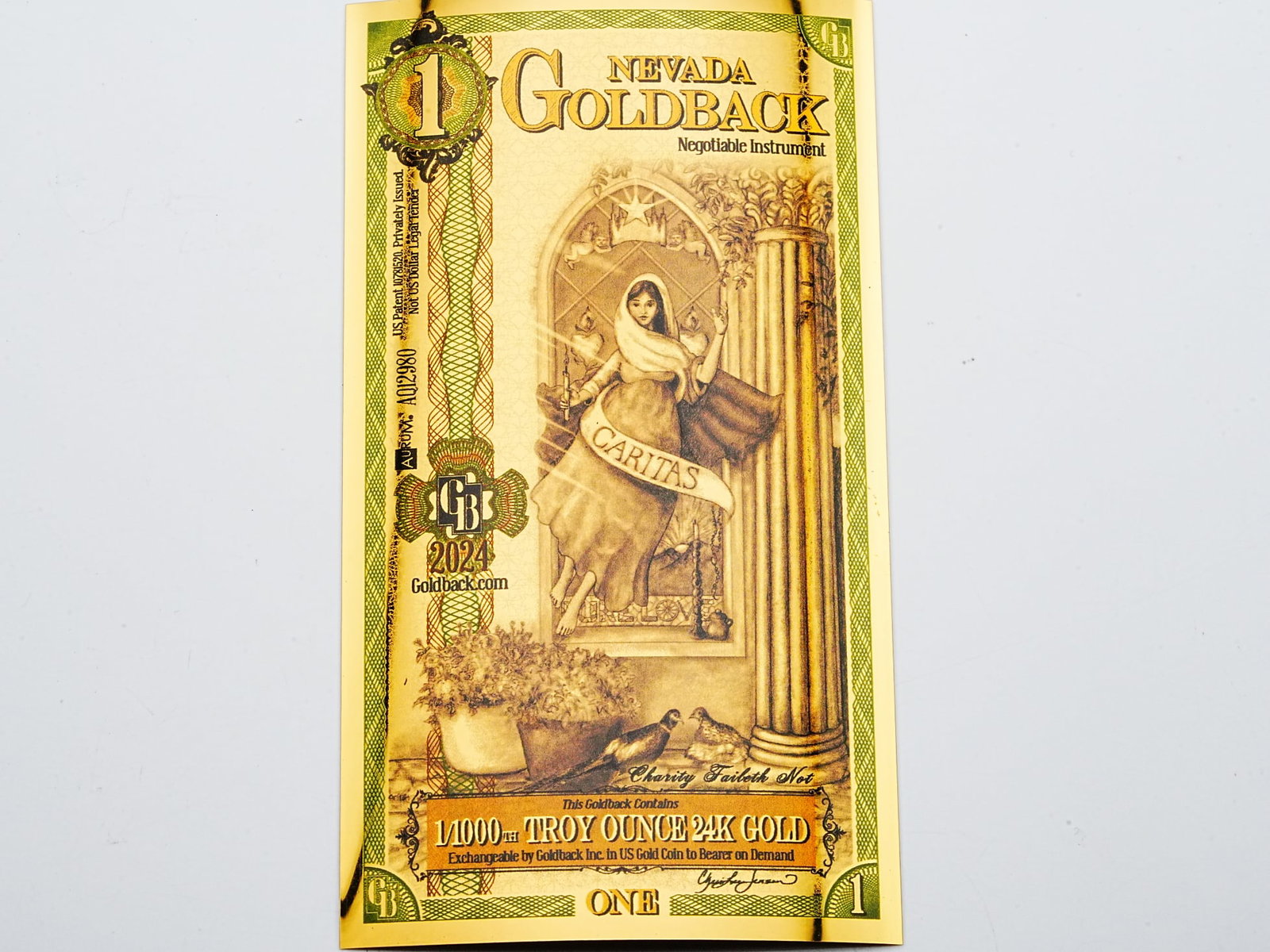 1 Nevada Goldback 1/1000th Troy Ounce 24K Gold: 1 Nevada Goldback 1/1000th Troy Ounce 24K Gold - A beautifully crafted Nevada Goldback note containing 1/1000th troy ounce of 24K gold, combining tangible precious metal value with intricate artistic