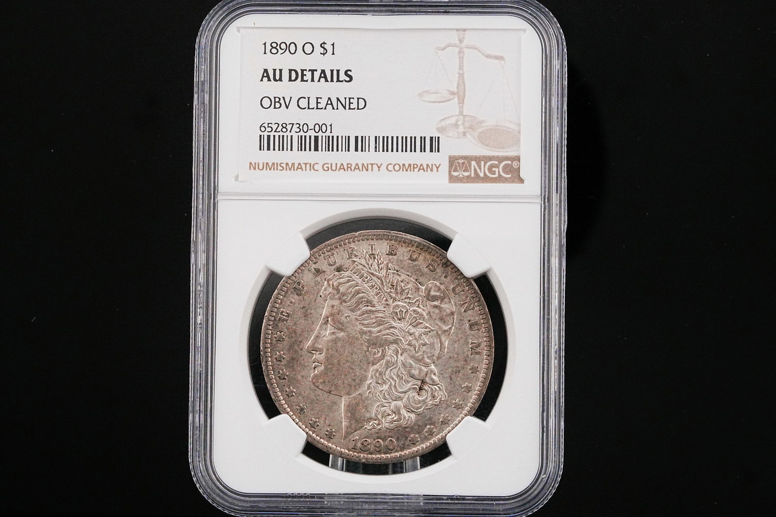 1890-O Morgan Dollar NGC AU Details Obverse Cleaned: 1890-O Morgan Silver Dollar NGC AU Details Obverse Cleaned - A visually commanding survivor from the golden age of American silver coinage, this 1890-O Morgan Silver Dollar captures the enduring appea