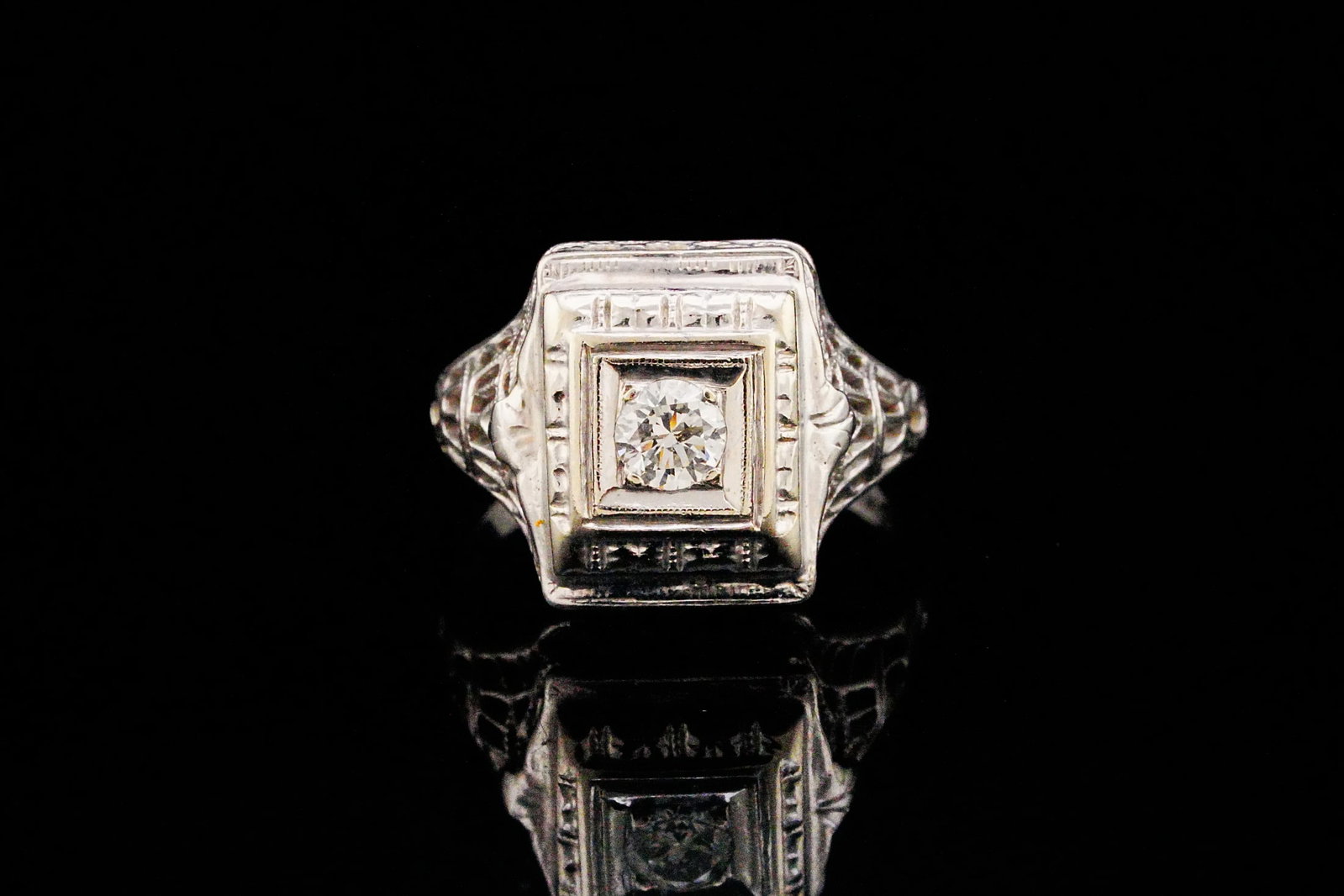 18K White Gold and 0.20ct Diamond Vintage Ring: 18K White Gold and 0.20ct Diamond Vintage Ring - A striking expression of early 20th-century elegance, this vintage ring is masterfully crafted in lustrous 18K white gold and centered around an approx