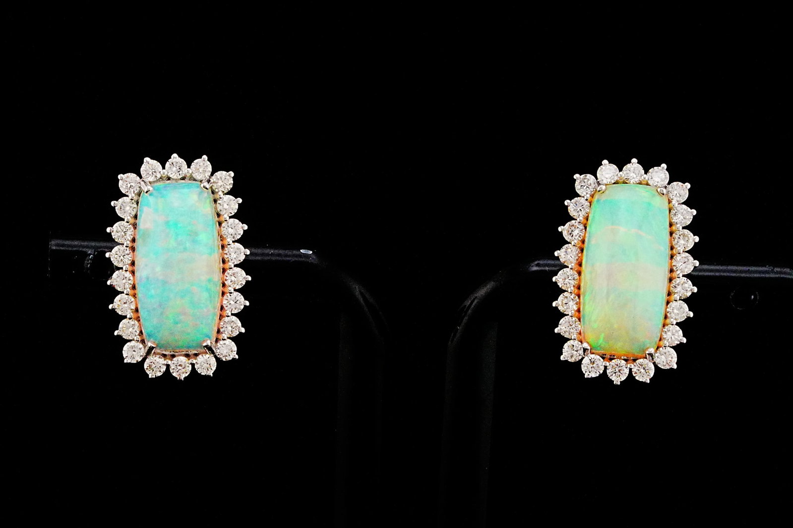 4.60ctw Opal, 1.00ctw Diamond and 18K 0.75" Earrings: 4.60ctw Opal, 1.00ctw VS2-SI1/G-H Diamond and 18K White Gold 0.75" Earrings - THIS ITEM WILL COME WITH A $6,500 INSURANCE VALUATION REPORT. Graceful and luminous, these exquisite earrings showcase app