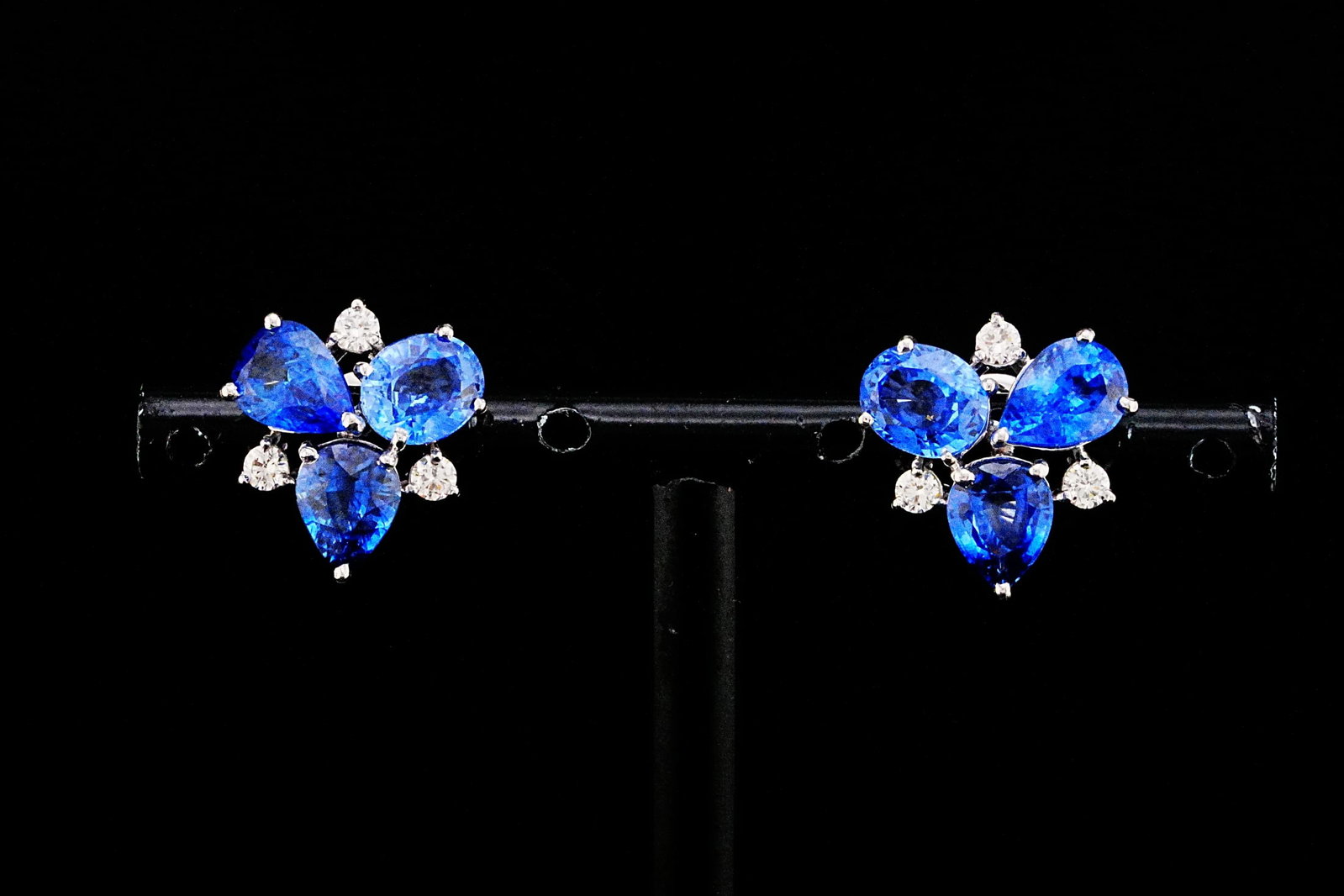 7.20ctw Blue Sapphire, 0.35ctw Diamond, 18K Earrings: 7.20ctw Blue Sapphire, 0.35ctw VS2-SI1/G-H Diamond and 18K White Gold 0.50" Cluster Earrings - THIS ITEM WILL COME WITH A $16,000 INSURANCE VALUATION REPORT. Elegant and captivating, these refined clu