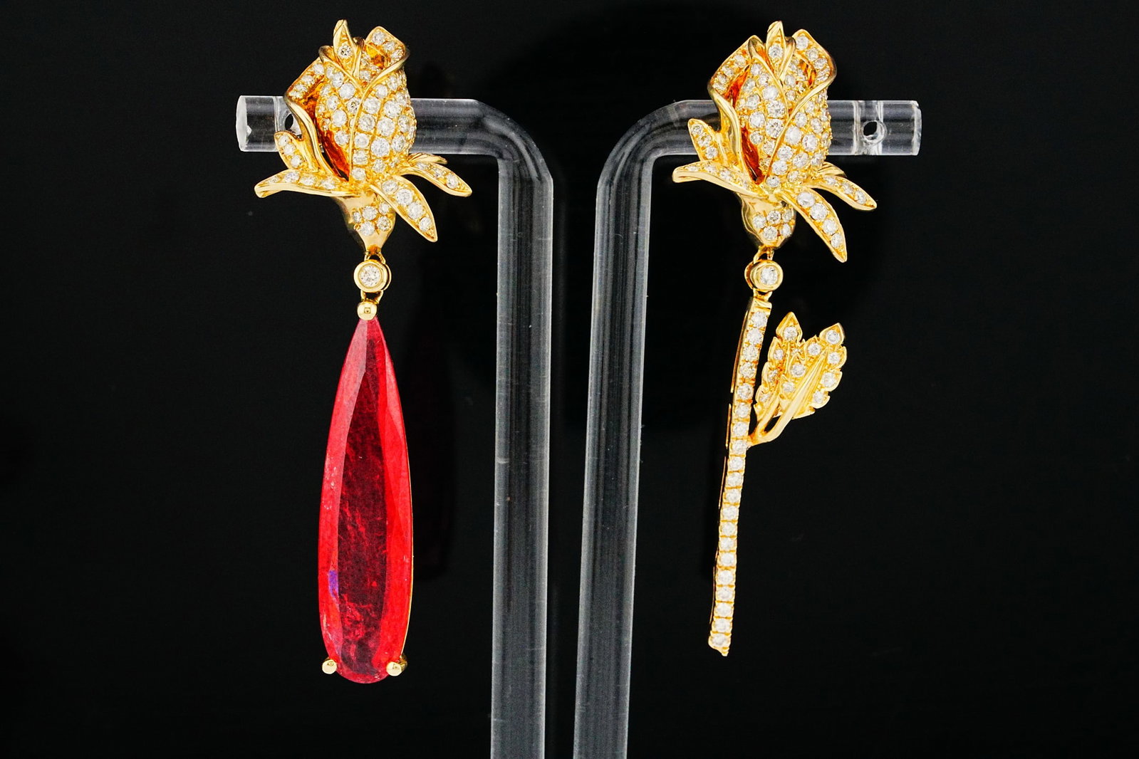 10.85ct Rhodonite, 2.00ctw Diamond 14K Earrings: 10.85ct Rhodonite, 2.00ctw Yellow and White Diamond 14K Yellow Gold Asymmetrical Drop Earrings - THIS ITEM WILL COME WITH A $33,000 INSURANCE VALUATION REPORT. A dramatic and artistic expression of fi