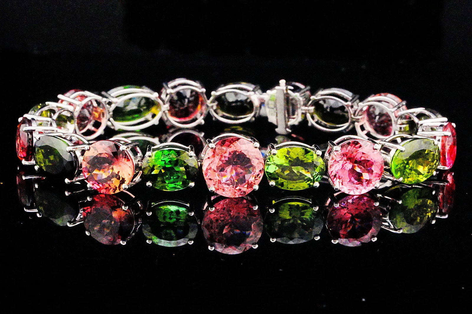 49.10ctw Pink and Green Tourmaline 18K 7.25" Bracelet: 49.10ctw Pink and Green Tourmaline 18K White Gold 7.25" Bracelet - THIS ITEM WILL COME WITH A $16,000 INSURANCE VALUATION REPORT. A vibrant celebration of color and fine craftsmanship, this extraordin