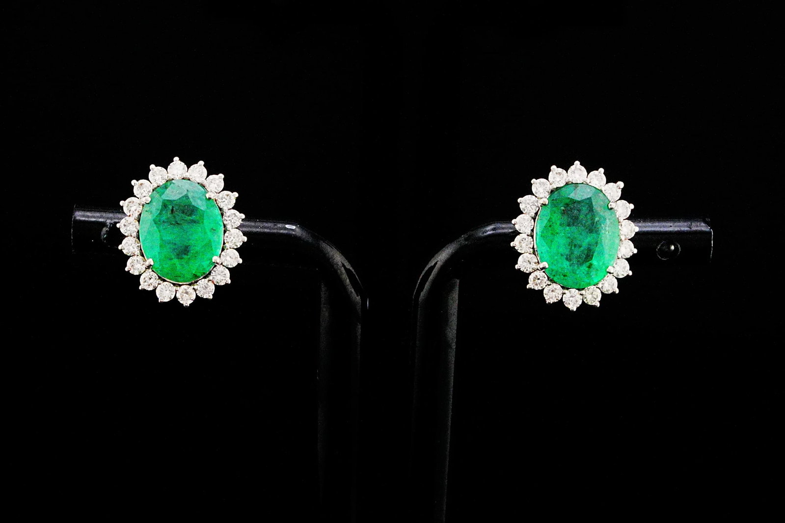 4.60ctw Emerald, 0.90ctw Diamond and 18K Earrings: 4.60ctw Emerald, 0.90ctw SI1-SI2/G-H Diamond and 18K White Gold 0.60" Stud Earrings - THIS ITEM WILL COME WITH AN $8,000 INSURANCE VALUATION REPORT. A timeless expression of elegance and sophisticatio