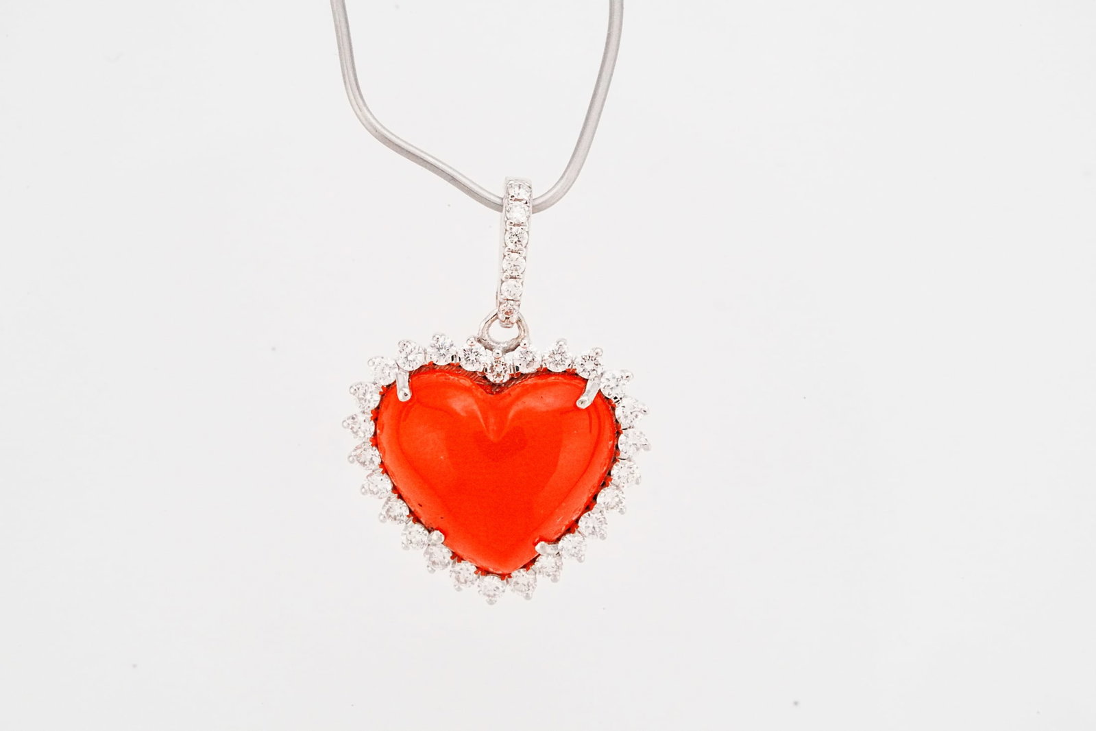 4.00ct Coral, 0.50ctw Diamond and 18K 1" Pendant: 4.00ct Coral, 0.50ctw VS2-SI1/G-H Diamond and 18K White Gold 1" Pendant - THIS ITEM WILL COME WITH A $4,250 INSURANCE VALUATION REPORT. Romantic and timeless in design, this elegant pendant showcases 