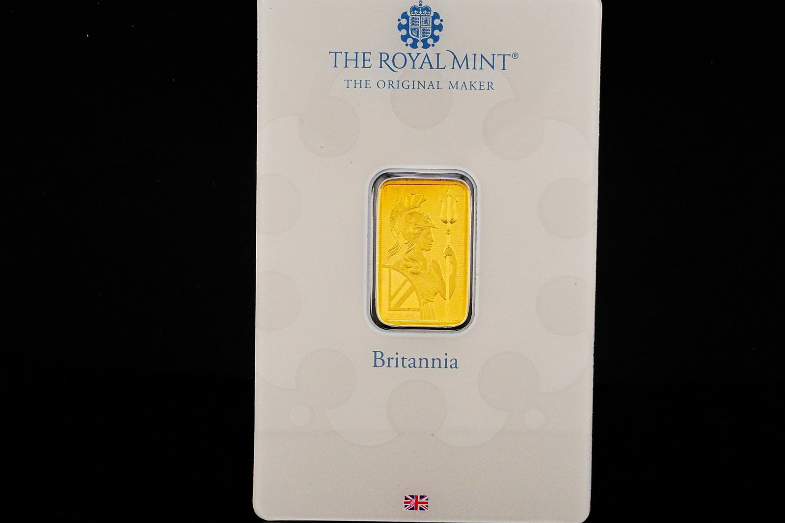 The Royal Mint 5 Gram .9999 Fine Gold Britannia Bar: The Royal Mint 5 Gram .9999 Fine Gold Britannia Bar in Assay Card - An elegant representation of British minting excellence and precious metal purity, this Royal Mint Britannia gold bar contains 5 gra