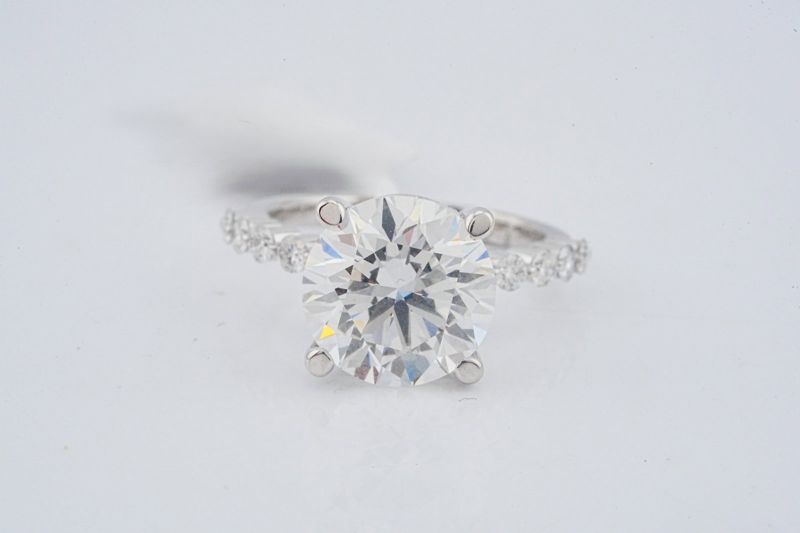 5.10ct IGI VS1/F Lab Grown Diamond, Diamond and 18K Ring: 5.10ct IGI Certified VS1/F Lab Grown Diamond, 0.70ctw Diamond and 18K White Gold Ring - THIS ITEM WILL COME WITH A $14,000 INSURANCE VALUATION REPORT. Centered by a brilliant 5.10 carat IGI certified 