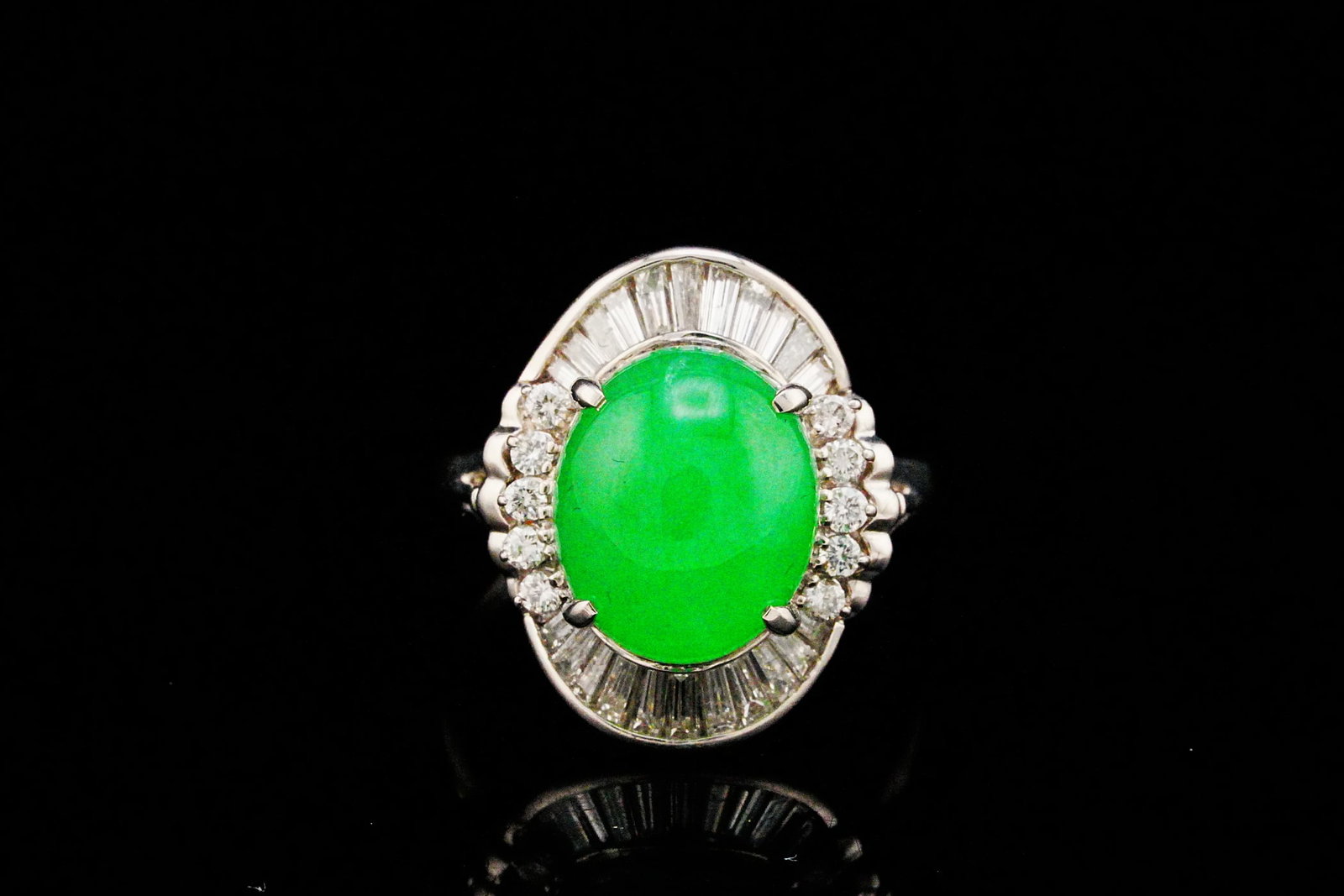 8.05ct Jade, 1.01ctw Diamond and Platinum Ring: 8.05ct Jade, 1.01ctw VS2-SI1/G-H Diamond and Platinum Ring - This elegant platinum ring is centered by an approximately 8.05 carat oval jade cabochon, prized for its rich color, luminous translucency,