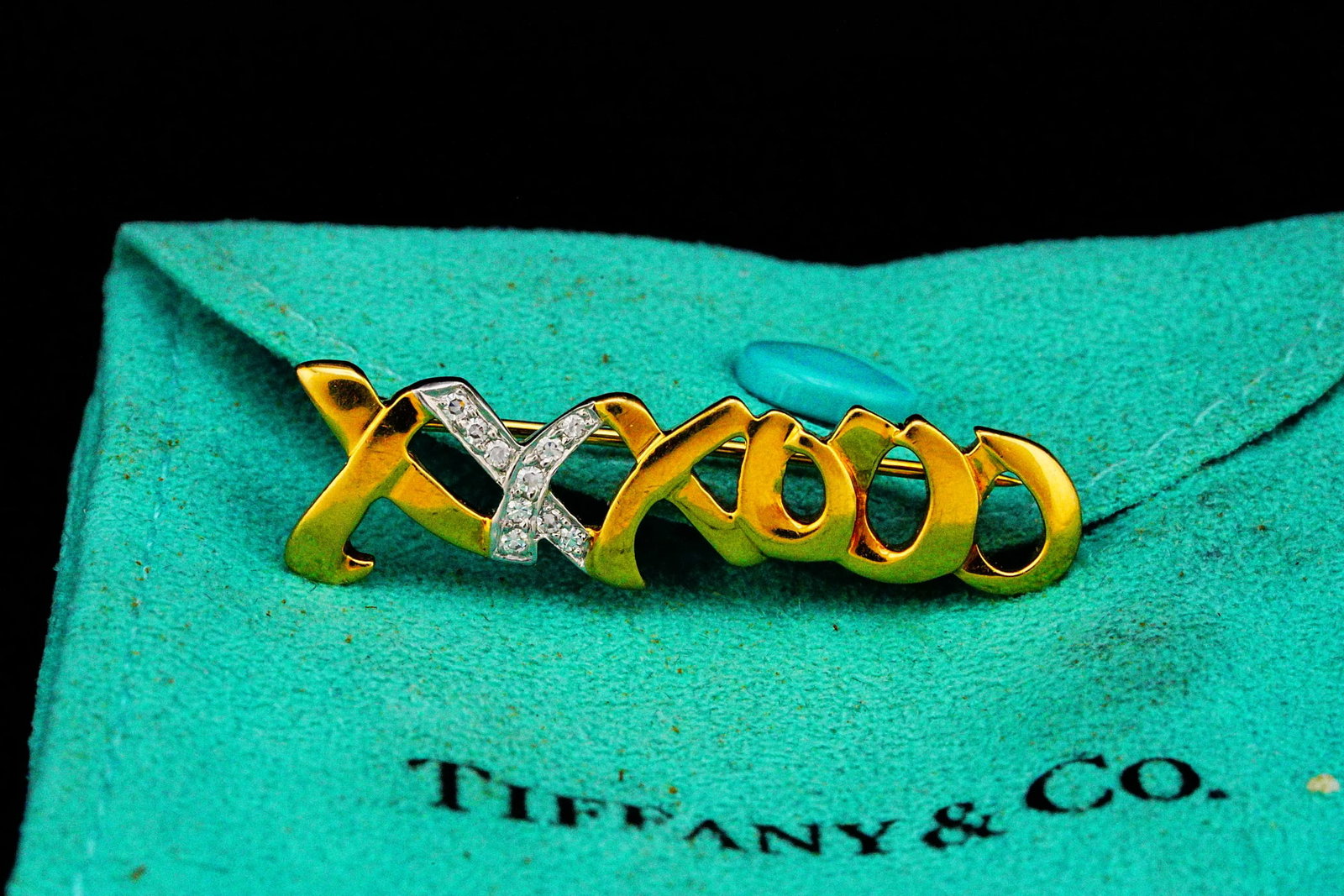 Tiffany & Co. Paloma Picasso Diamond, 18K/Plat Brooch: Tiffany & Co. Paloma Picasso Diamond, 18K Yellow Gold and Platinum XXXOOO Brooch W/Pouch - This iconic Tiffany & Co. brooch, designed by renowned artist Paloma Picasso, showcases her celebrated XXXOOO