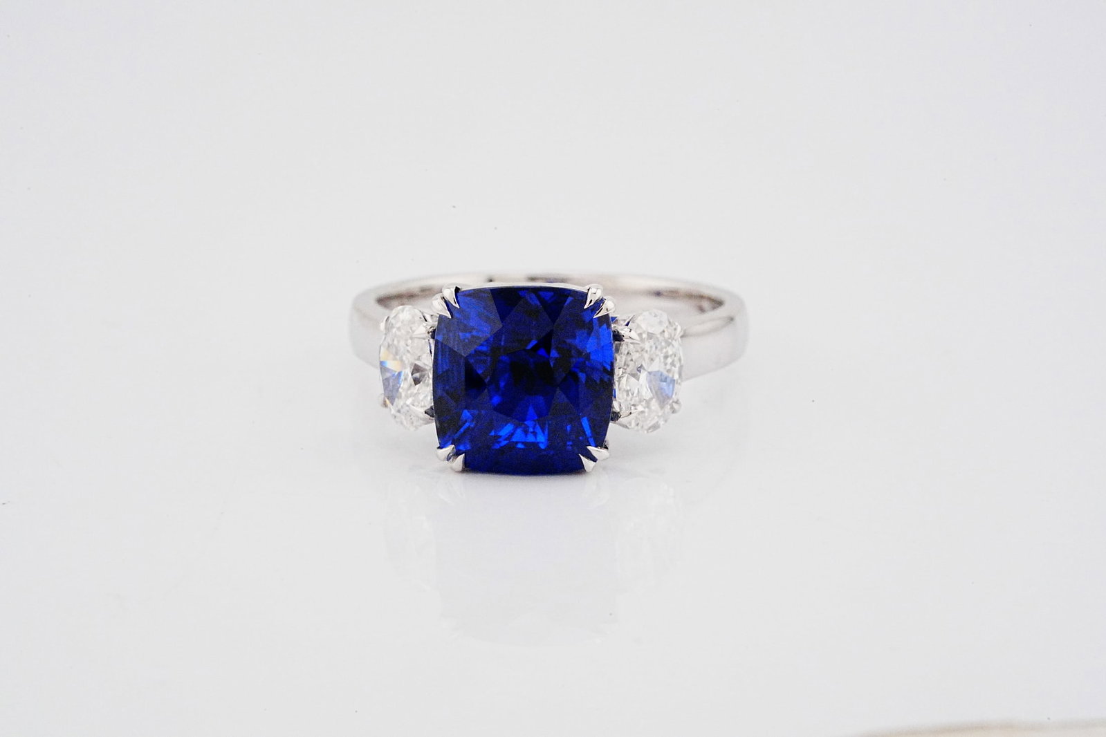 5.40ct Blue Sapphire, 1.00ctw Diamond and 18K Ring: 5.40ct Blue Sapphire, 1.00ctw SI2/G-H Diamond and 18K White Gold Ring - THIS ITEM WILL COME WITH A $79,500 INSURANCE VALUATION REPORT. A striking display of color and elegance, this exceptional ring s