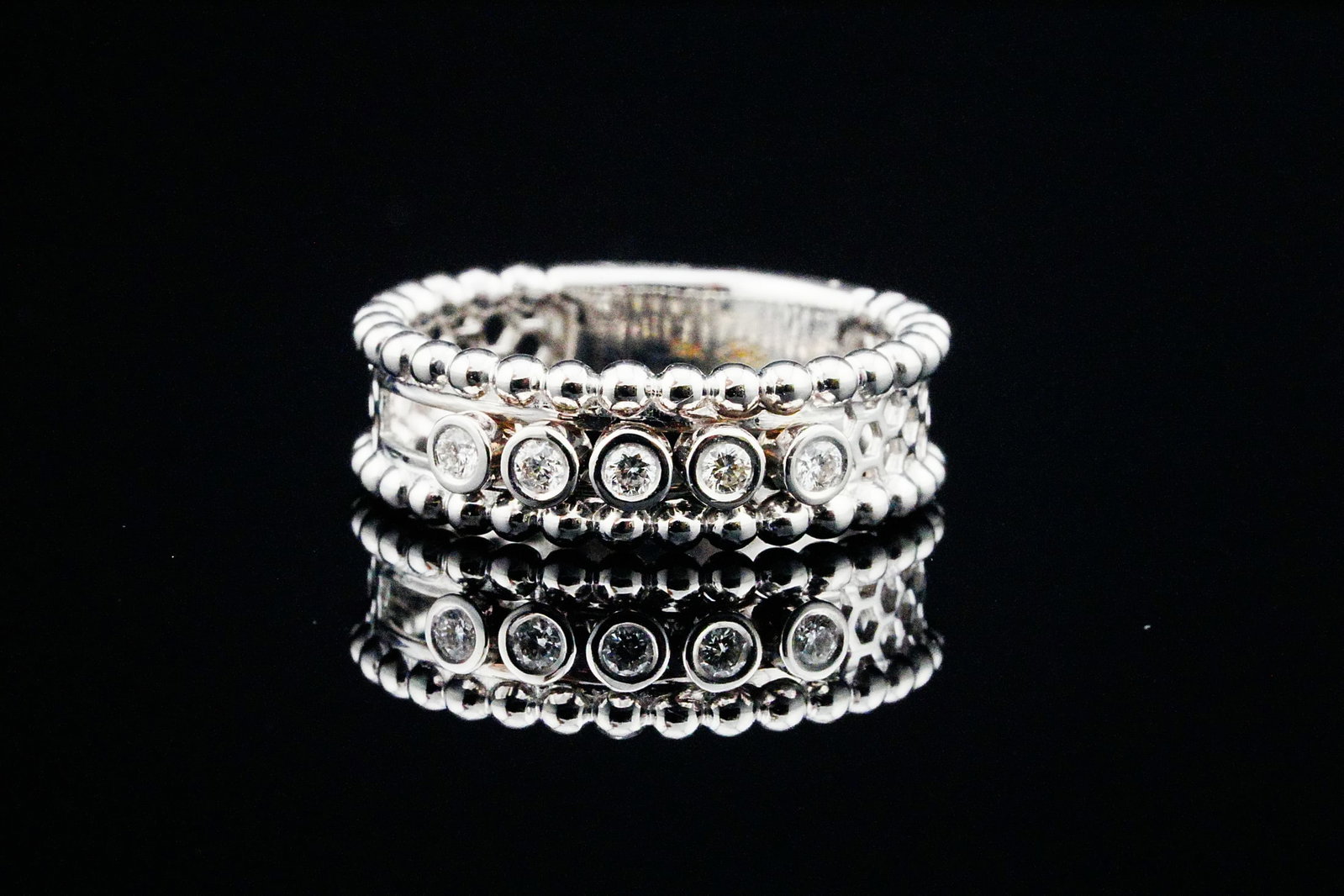 18K White Gold and 0.35ctw Sliding Diamond Band: 18K White Gold and 0.35ctw Sliding Diamond Band - A contemporary and ingeniously engineered 18K white gold ring showcasing approximately 0.35 carats total weight of round brilliant-cut diamonds, each 